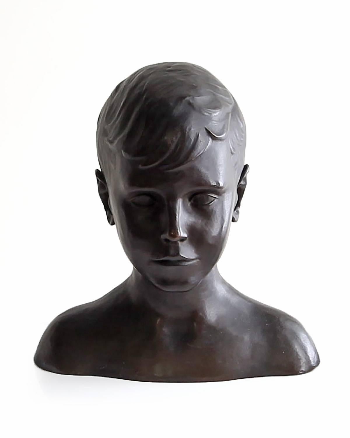 This bronze bust of a handsome young man will bring both beauty and style to your bookshelf or coffee table. The form of the figure celebrates both the youth and innocence of the subject, while allowing the viewer to contemplate and appreciate the