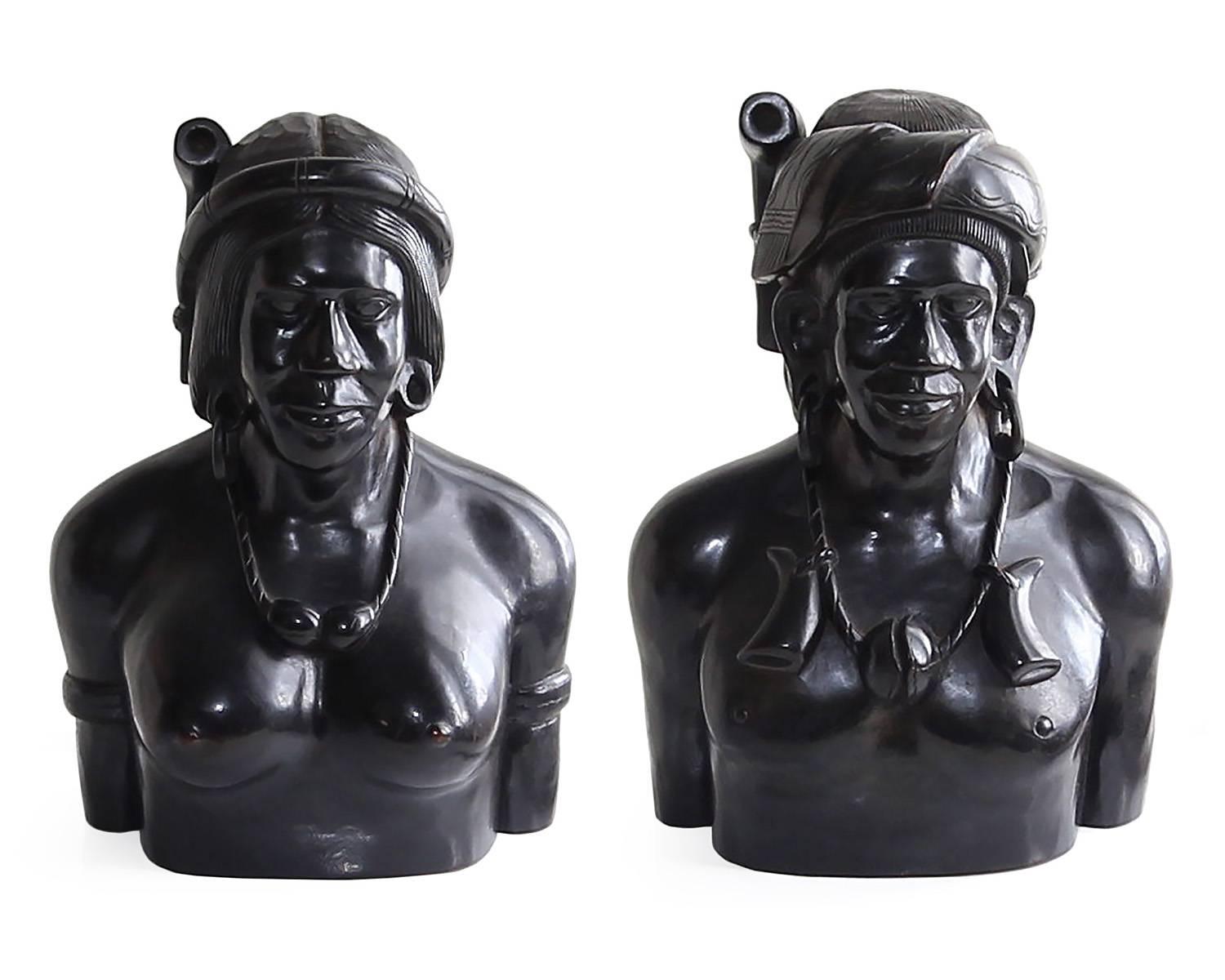 This pair of hand-carved wooden busts are truly a special find and a magnificent example of folk tribal art. Care and craftsmanship are clearly evident in these pieces as facial features, jewelry and hair are all careful executed. A dark, rich