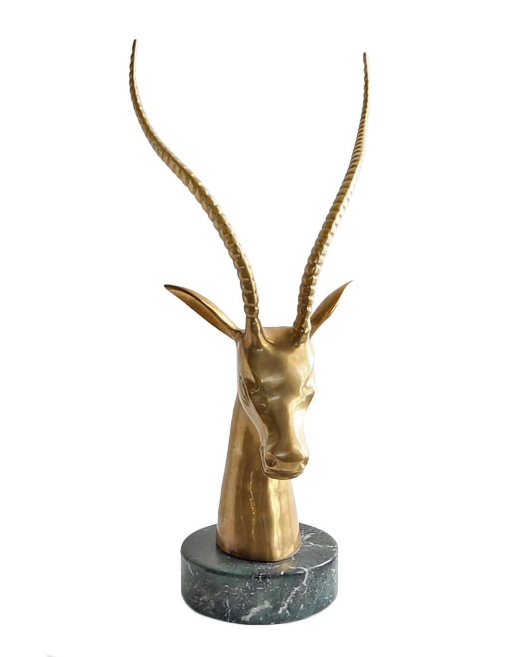 This gorgeous Mid-Century brass impala sculpture is impressive in its size and scale. It is mounted to green marble base and is nearly 21 inches tall. Beautiful original patina give this a touch of Mid-Century glamour. Unmarked but attributed to