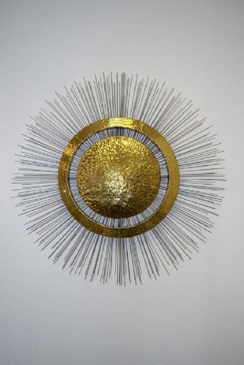 This large and impressive piece is comprised of a heavy brass center and concentric ring accented by hundreds of steel rods. Brutalism influence is evident. The piece is not signed, but is in excellent condition and presents beautifully. It's a
