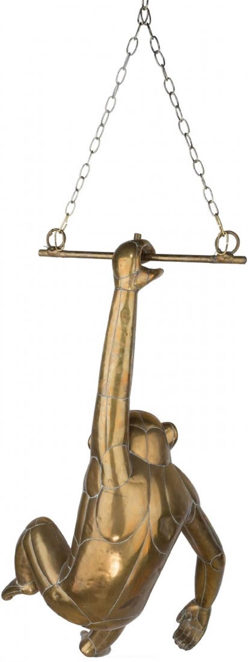 This charming sculpture by Mexican artist and sculptor Sergio Bustamante (b. 1949) depicts a chimpanzee hanging from a trapeze bar. Each piece has been expertly crafted and then carefully pieced together to create this lifesize piece. The expression