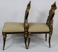 Pair of Carved French Empire Style Decorative Chairs of Ebonized and Giltwood