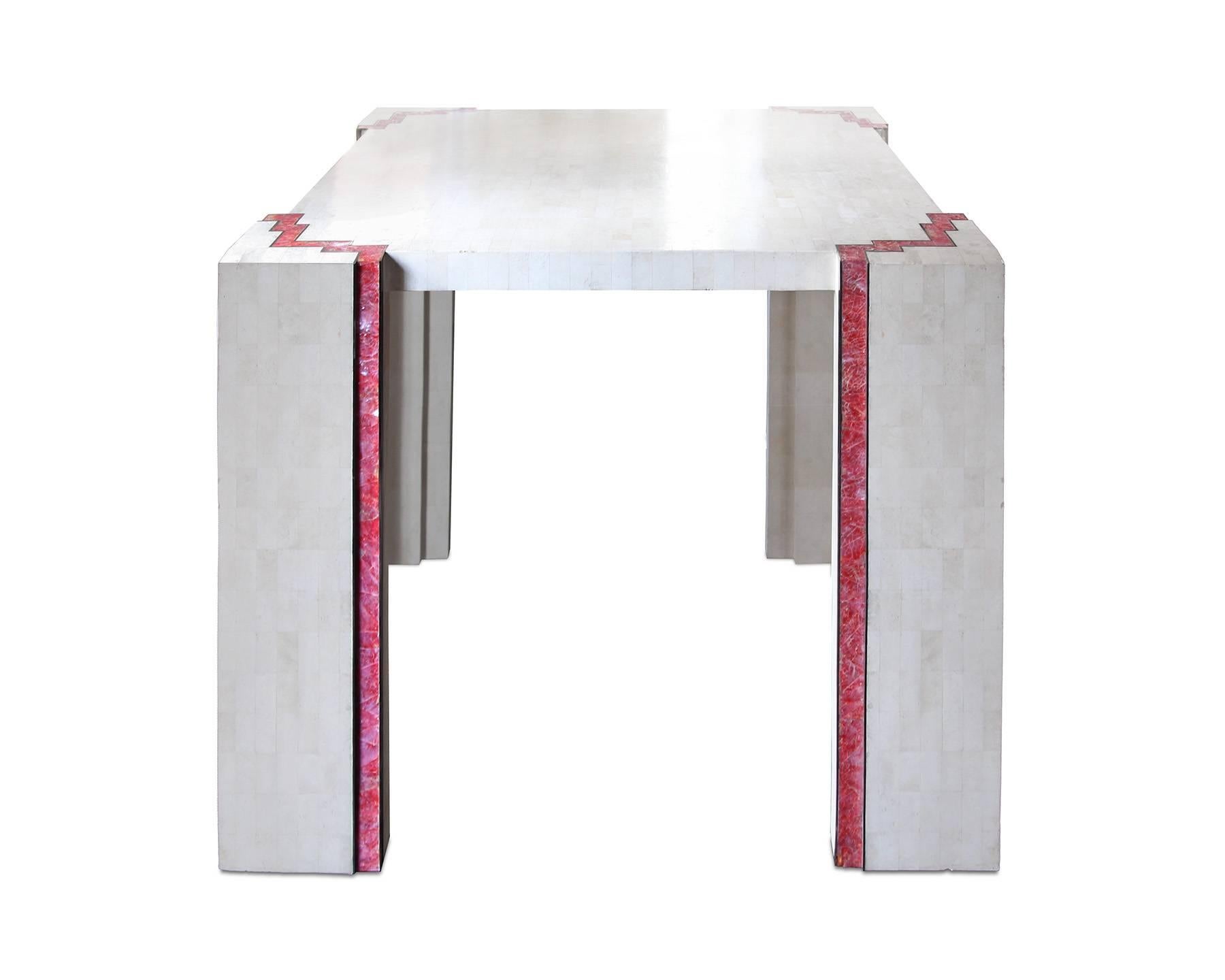 Unique and stunning four-top dining or game table of tessellated marble, pink stone and brass inlay. The stair-step design references Art Deco design and adds a touch of whimsy and color to this very unique piece. Unmarked but attributed to