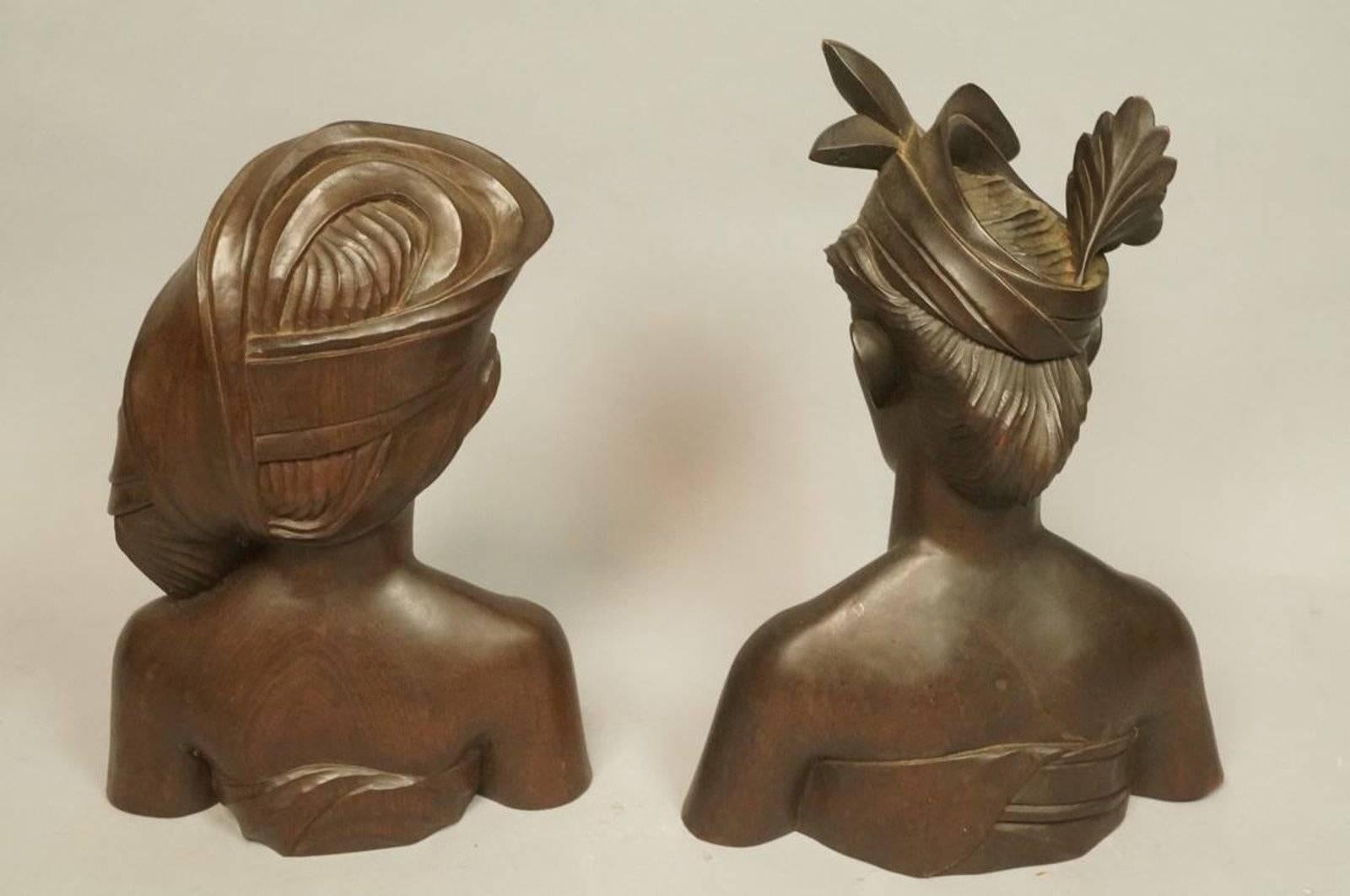 Beautiful carved wood bust of a male and female native of Indonesia. These are fine examples of traditional wood carving techniques. Very attractive and enjoyable specimens sure to liven up any bookshelf or tabletop display. Marked 'Indonesia' on