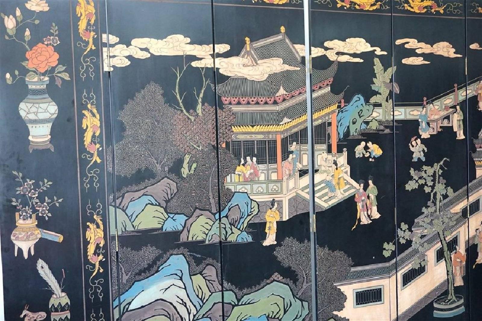 A large vintage Maitland Smith eight-panel Chinese Coromandel screen that measures 11 ft by 7 ft. An imperial palace and garden are hand-carved into the black lacquered panels. The back side is traditional 