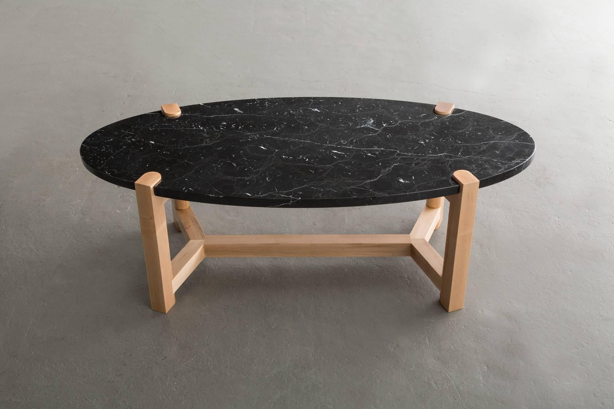 Here the details and connections become the focus at the intersection of surface and structure.

Solid wood frame shown in maple. Also available in ash, cherry, and walnut. 
Stone top shown in Nero Marquina marble and available in locally sourced,