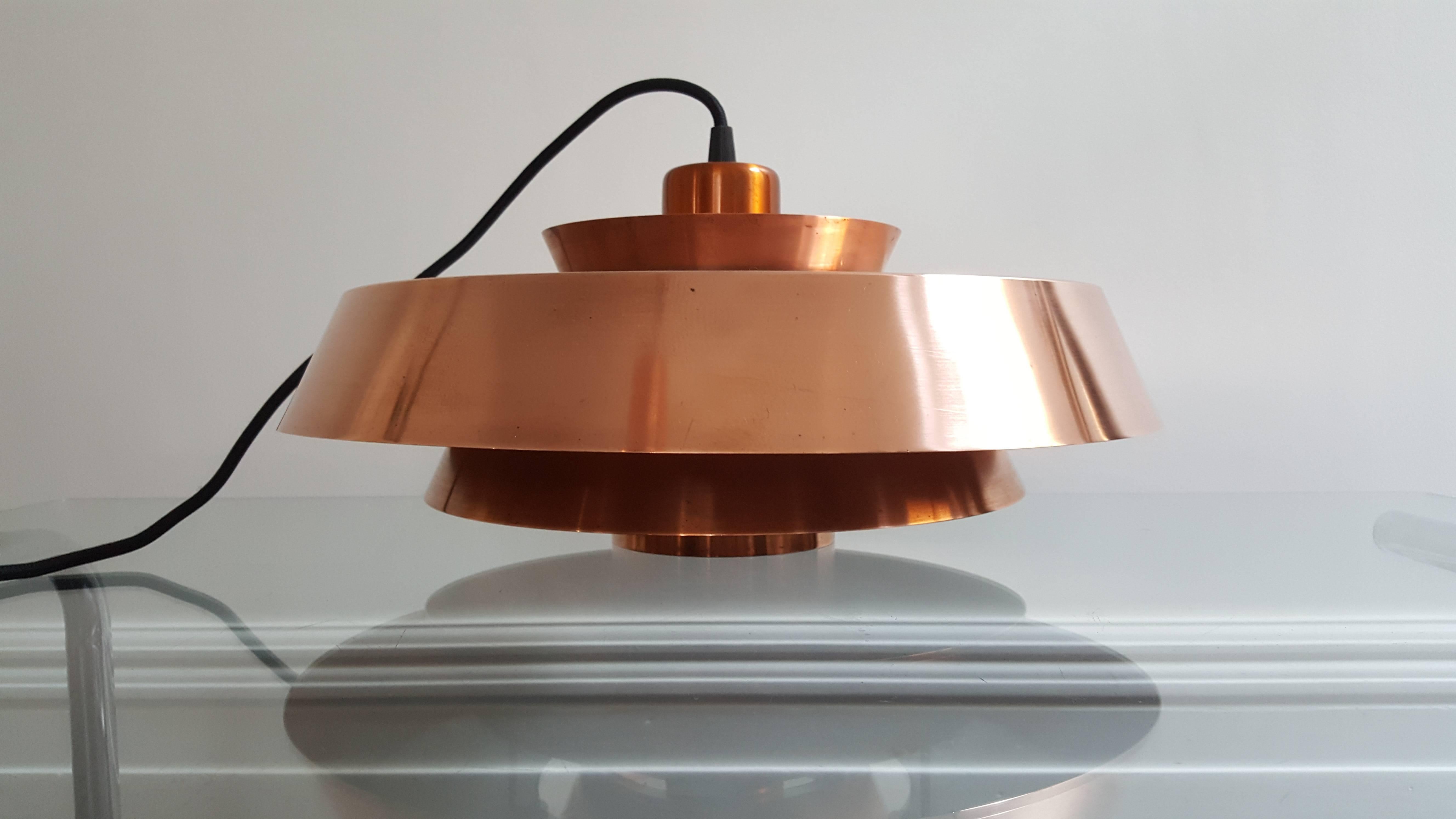 Jo Hammerborg Nova pendant light in copper for Fog & Mørup, Denmark, 1960s

This vintage, modernist light fixture is crafted in copper in three round, graduated tiers

In 1957 Jo Hammerborg became head of design at Fog & Mørup. His incumbency in