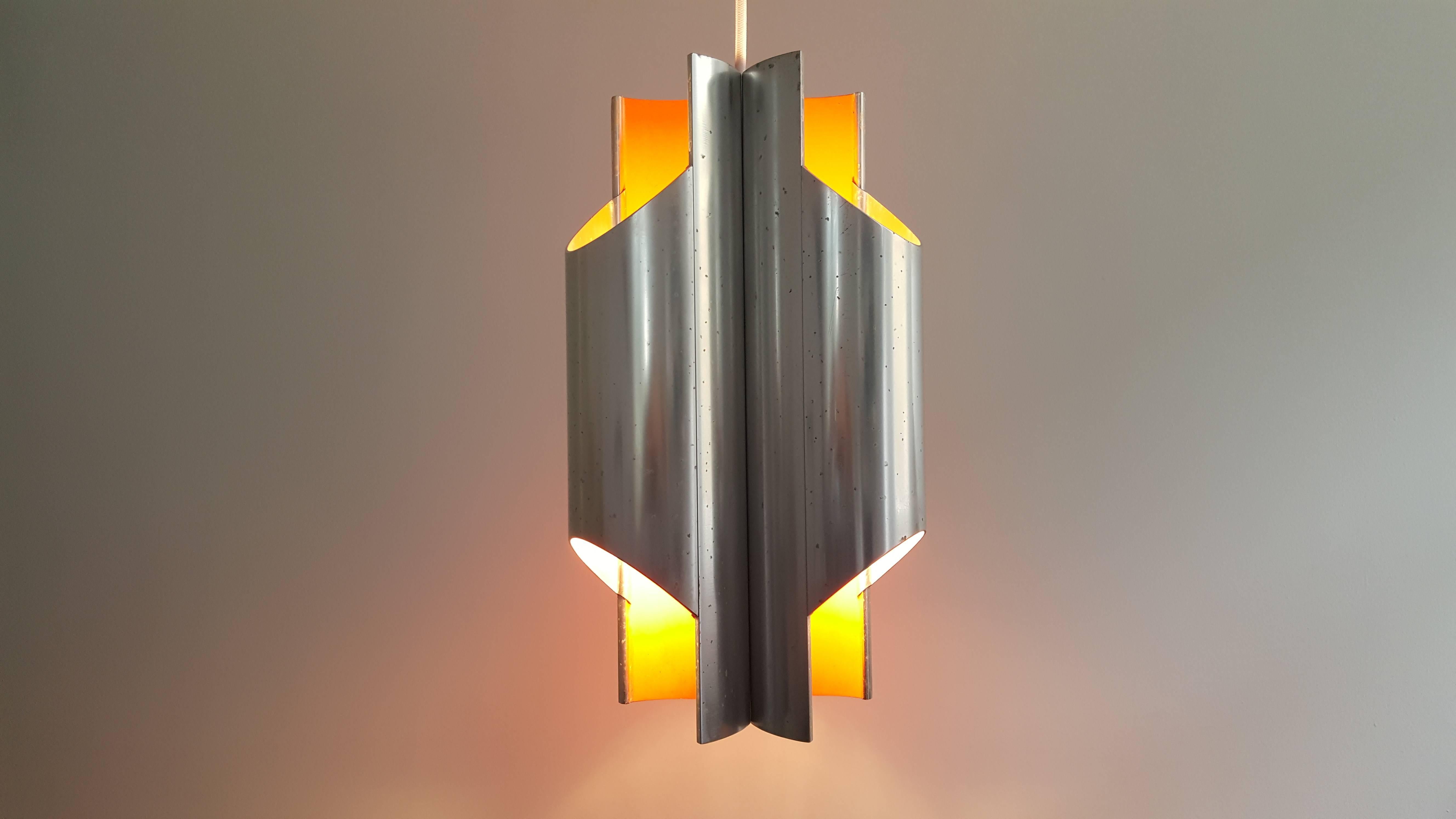 Bent Karlby 'Pantre' pendant for Lyfa, 1970.

The 'Pantre' pendant, referring to three (tre) pan flute designed aluminium elements was designed by Bent Karlby and produced by Lyfa. Each section has an red/orange inner along with a bulb holder, the