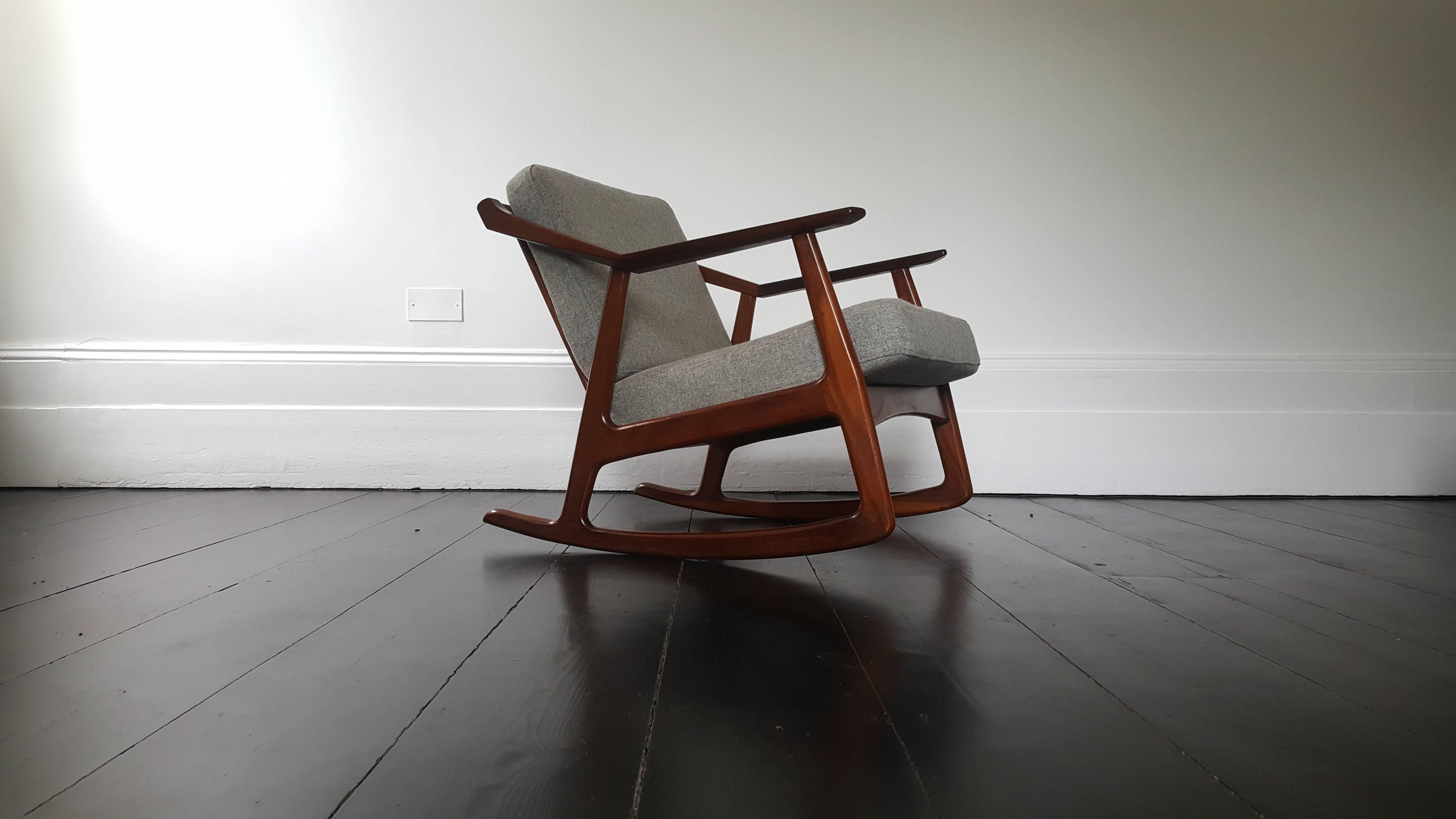 A rare Mid-century rocker designed by H. Brockmann-Petersen, with an angular refinished teak frame and new grey fabric with slight Herringbone detail the piece has a great look.

We provide very competitive global shipping rates per your