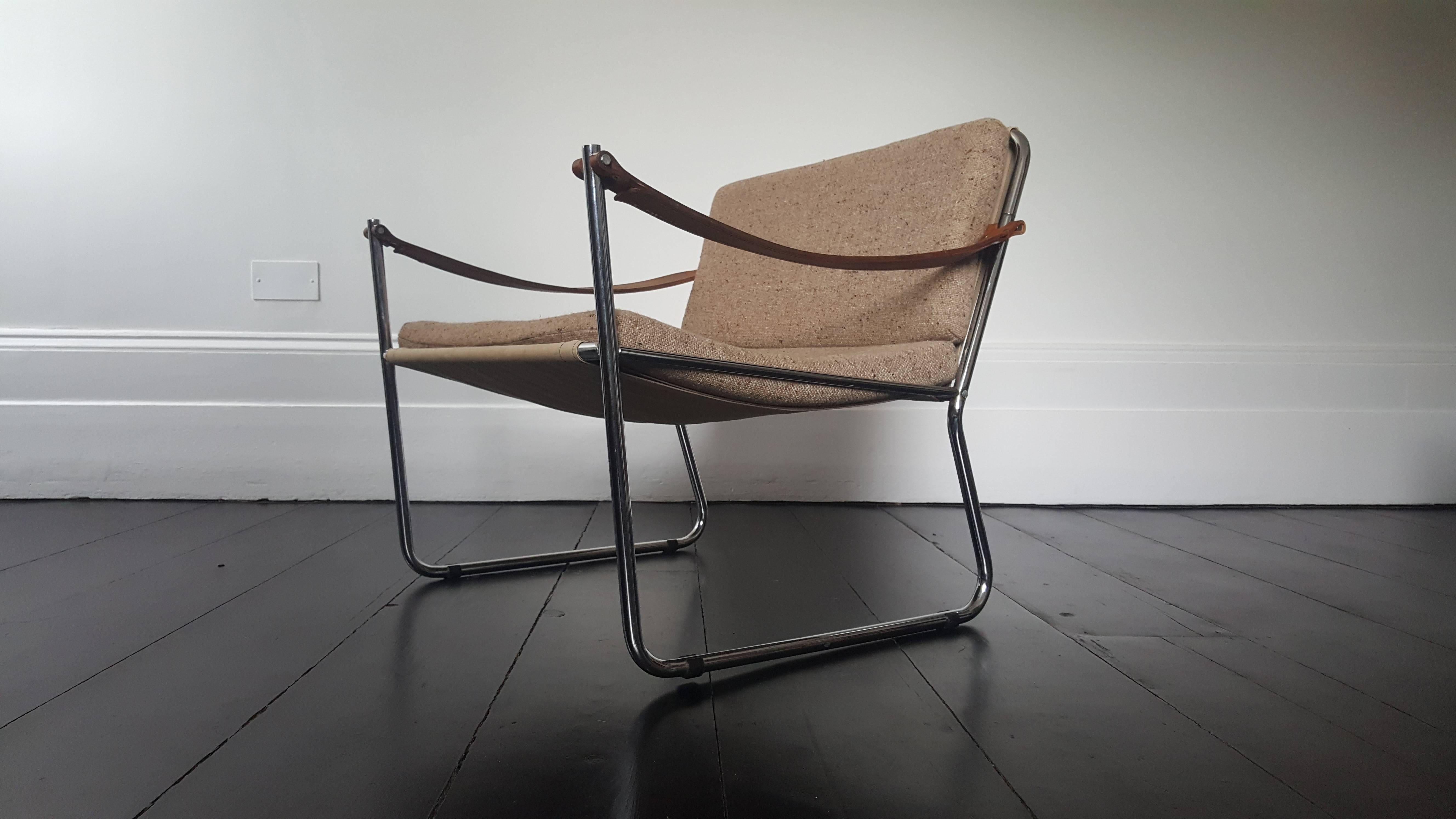 Scandinavian Furniture design, 1960s.

Featuring chrome-plated steel frame with stretched canvas and light brown upholstered cushions and suspended leather strap arms.