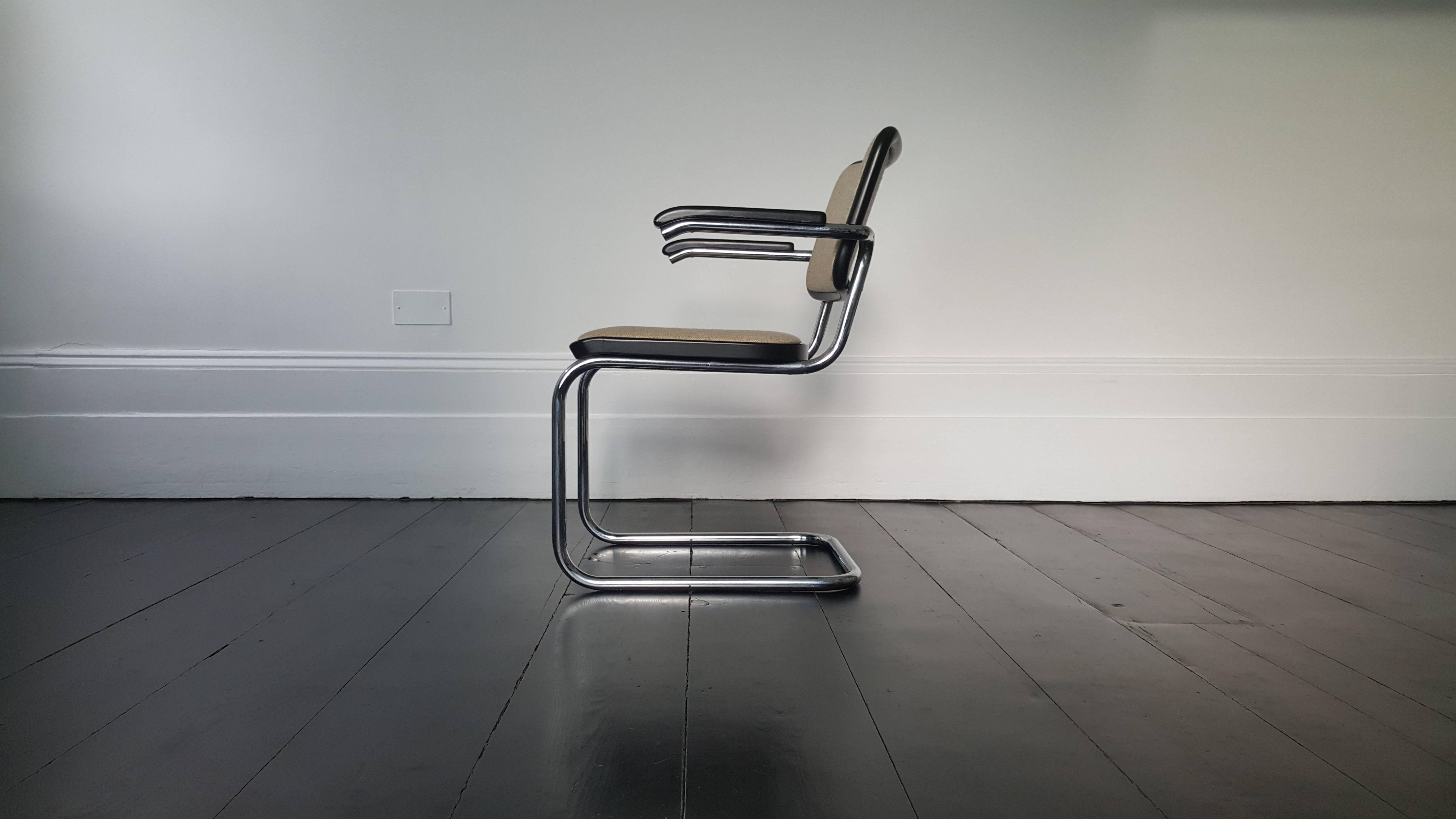 Marcel Breuer was a Hungarian-born modernist, architect and furniture designer.
 
This is one of his most iconic designs, the S 64 consisting of a cantilevered tubular steel frame, black lacquered wood and material upholstery and this original
