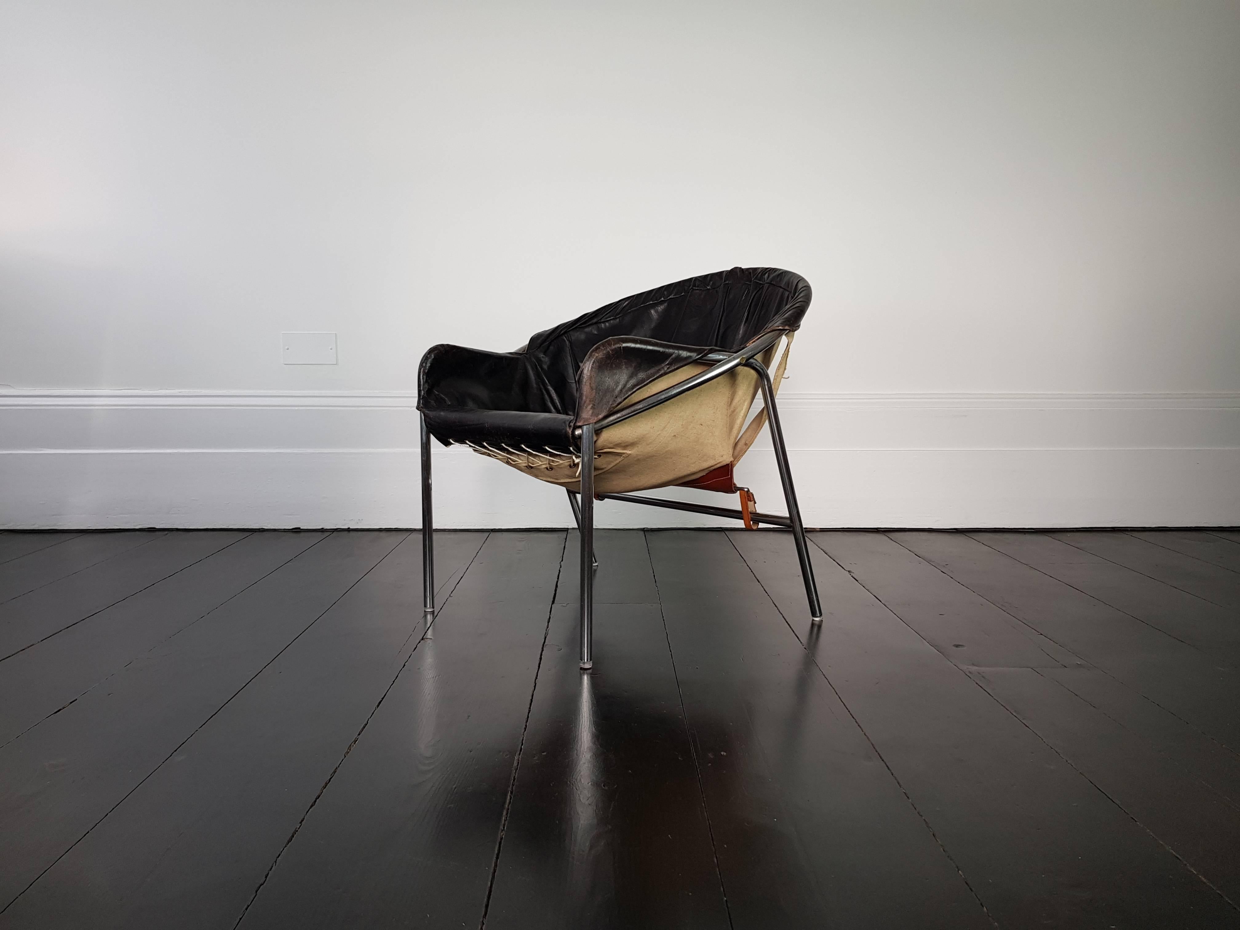 An Erik Ole Jørgensen armchair, model BO 360, Olaf Black for Bovirke, features a chrome-plated frame with canvas and leather sling. This is a scarce design and features in the Danish Design Museum.
 
Condition: Leather has a great patina, there is