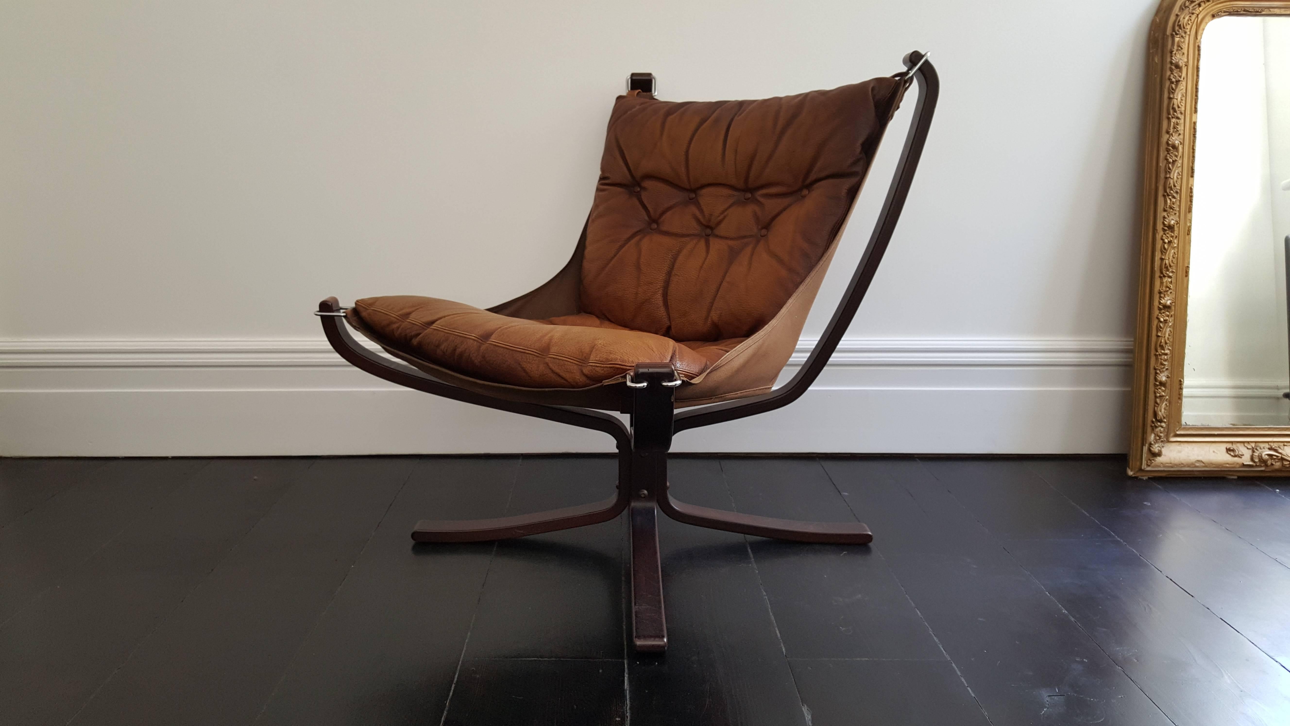 A super comfortable, amazing looking 1970s designed Sigurd Resell iconic Falcon chair. X-framed with hammock design.
 