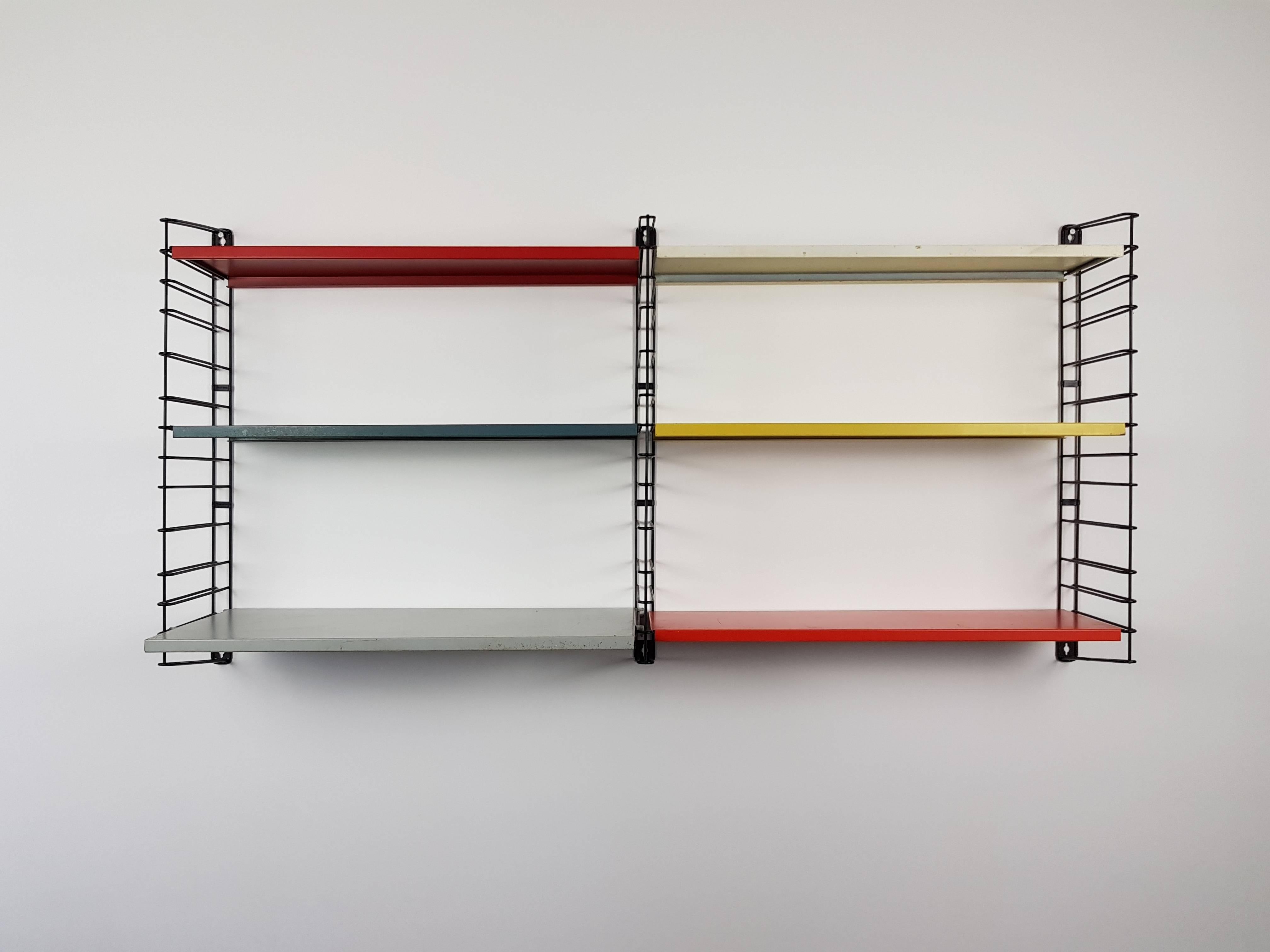 A Dutch design icon, Tomado hanging wall shelves, designed in the 1950s by A. Dekker.

This set featuring a rare perforated tray shelf.
?
Powder coated frame and adjustable steel shelves. This design looks amazing in any room and location and