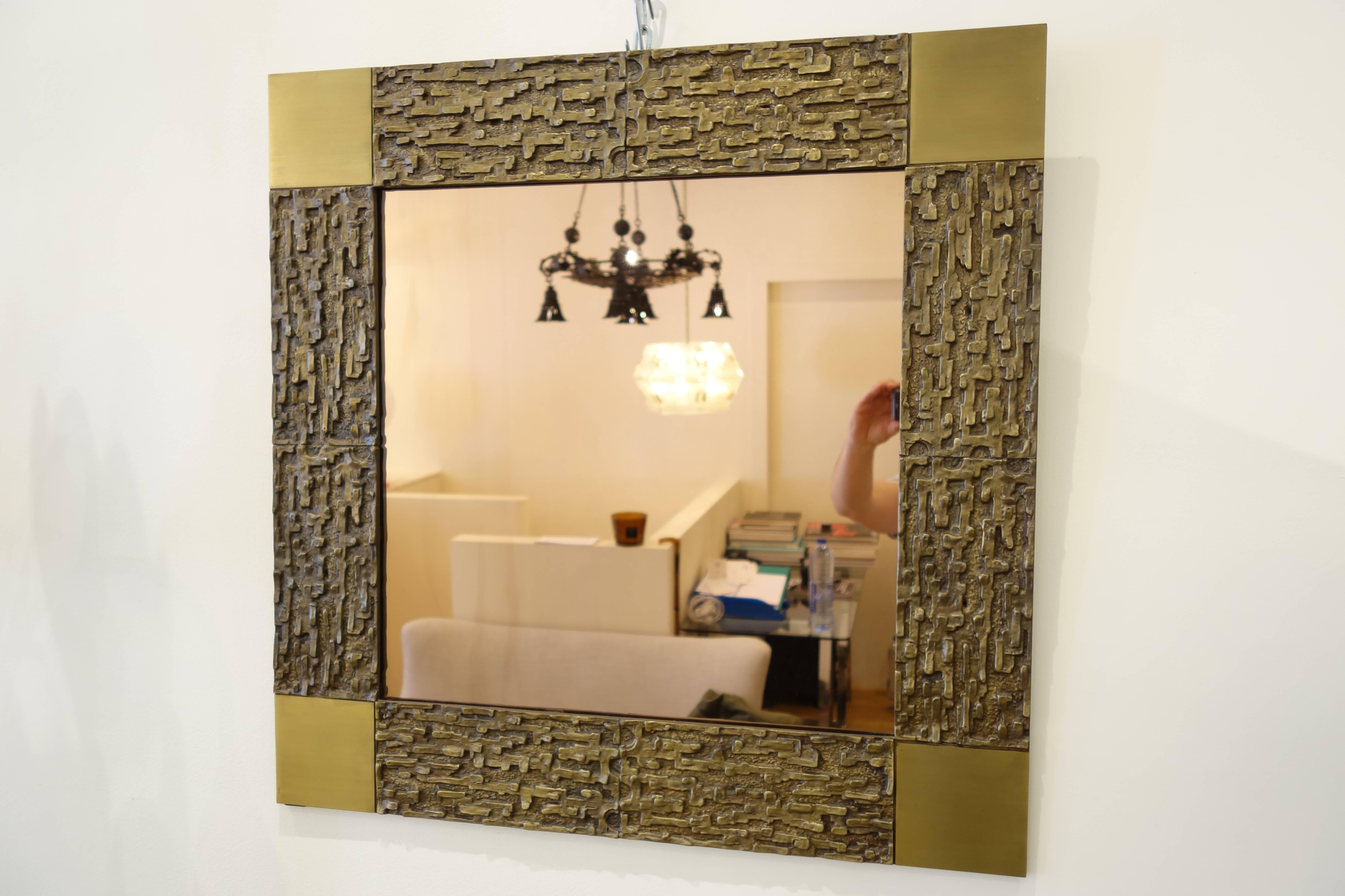 The mirror decorated with abstract pattern squared by polished square.