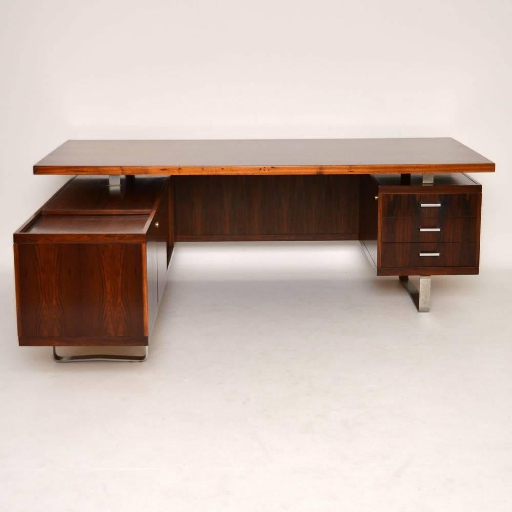 A magnificent Rosewood executive desk, this was designed by Jorgen Pedersen, and was made in Denmark during the 1960s. We have had this stripped and re-polished to a very high standard, the condition is superb for its age, with just some minor signs