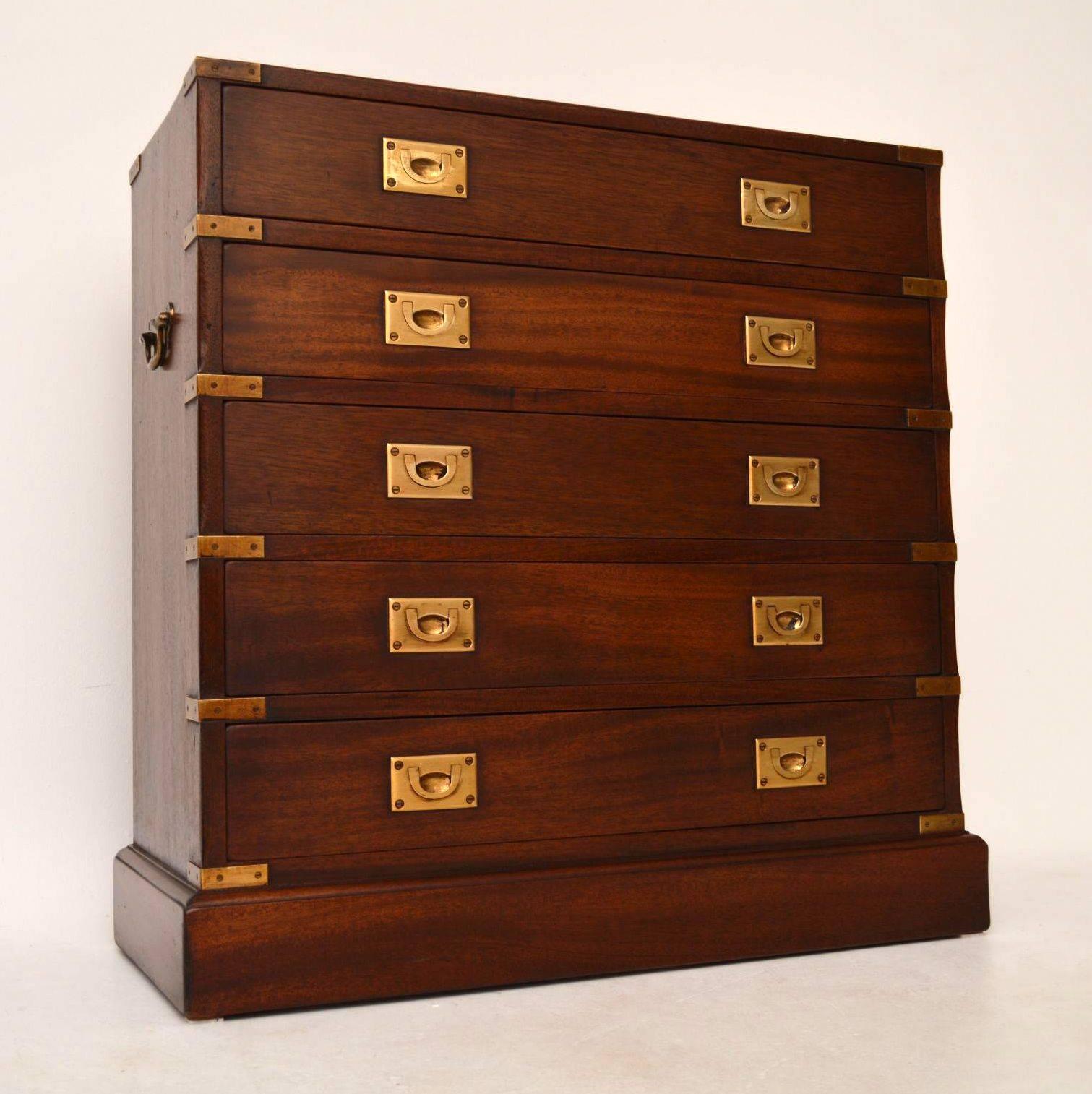 Antique campaign style mahogany chest of drawers with brass corners and brass inset military style handles. It also has brass carrying handles. This chest is in good condition, having just been polished and I would date it to around the 1930s