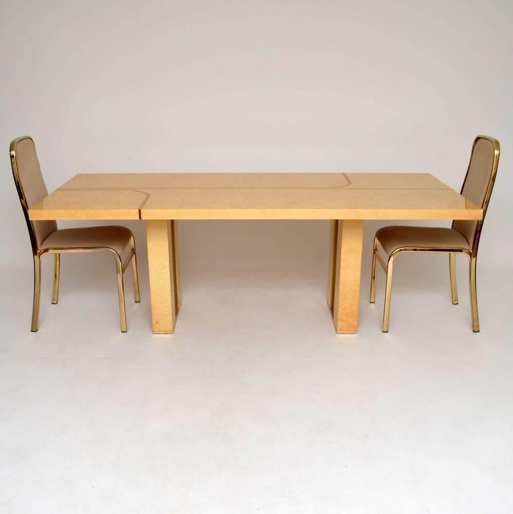 A stunning Italian dining table, this was designed by Renato Zevi and dates from the 1970s. Originally retailed exclusively in Harrods, this model is extremely rare, and it's beautifully made. The burr maple veneers have a beautiful colour and grain