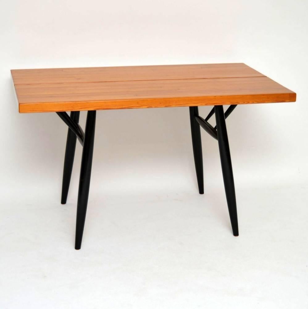 A beautiful and very rare dining table by Ilmari Tapiovaara, this was made in Finland during the 1950s. It is extremely well made, with a Pine top and ebonised wood base. We have had this stripped and re-polished to a very high standard, the