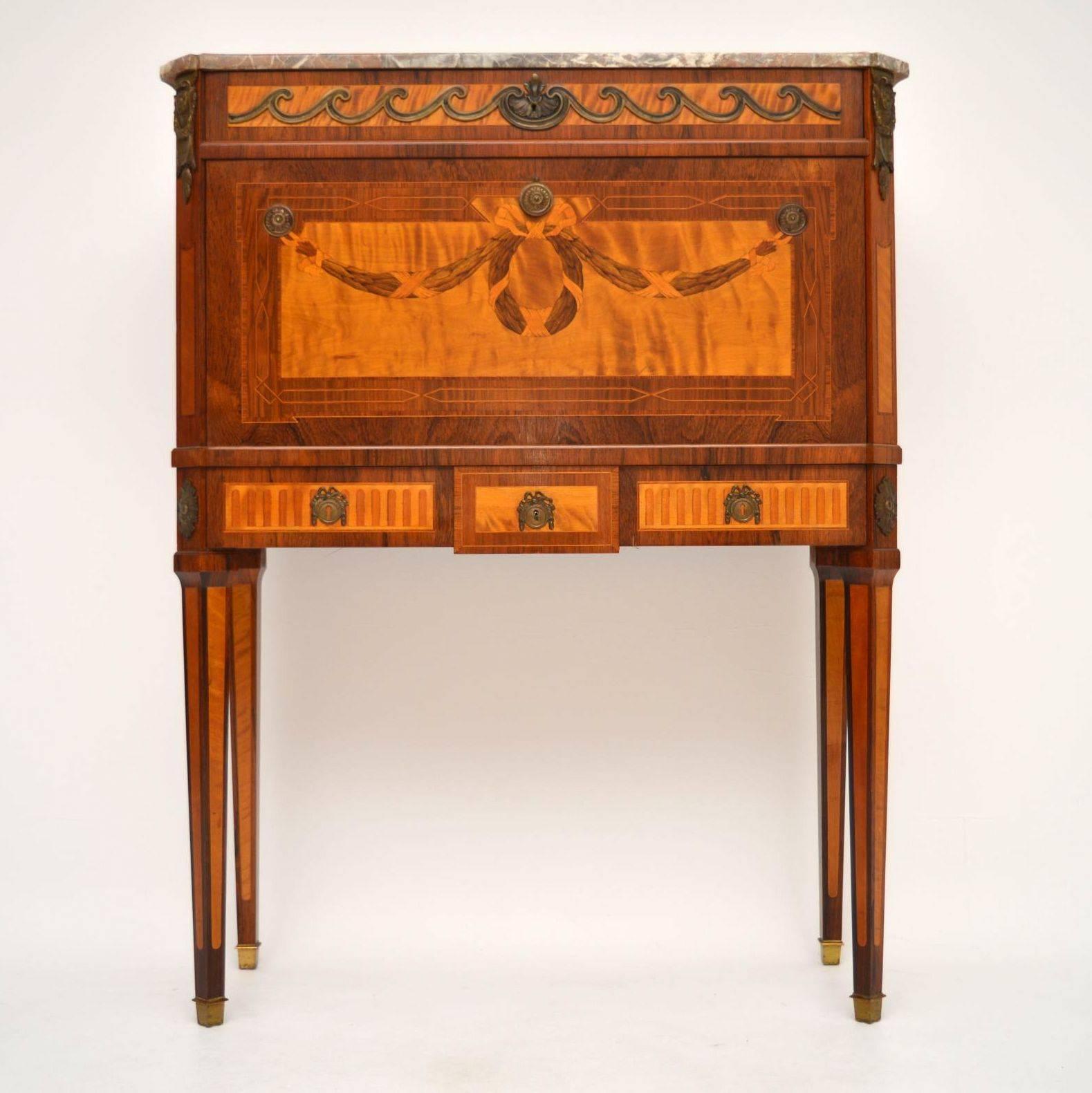 Antique Swedish marble top secretaire cabinet of fine quality with a stunning writing interior. It has a slim top drawer, a pull down writing surface, a bottom drawer and sitting on tapered inlaid legs with brass feet. This is an exceptional piece