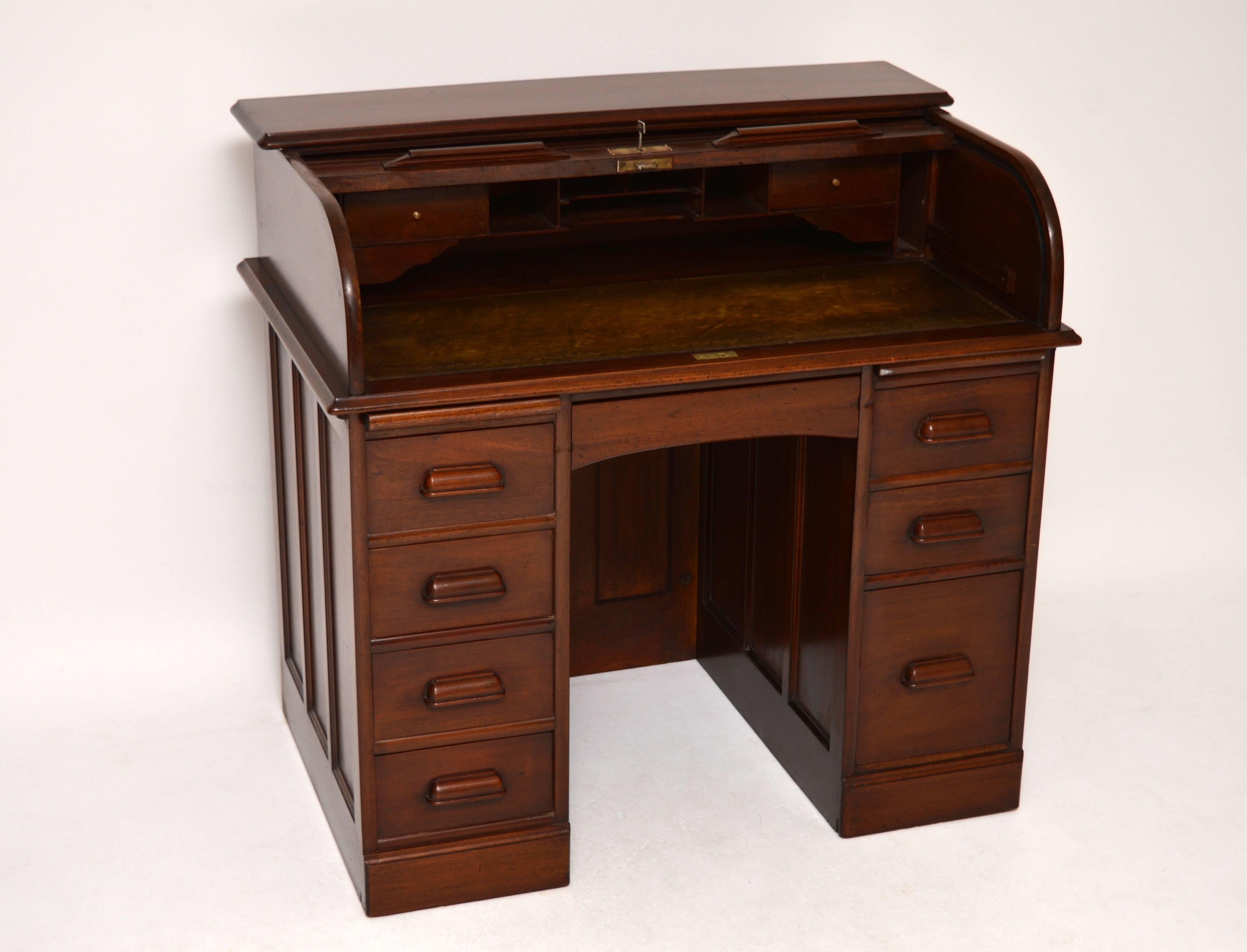 This antique mahogany roll top desk is a nice compact size and in good original condition, dating from around the 1910s-1920s period. It's also very well made with some nice features. This desk looks great from all angles. The back, inside back and