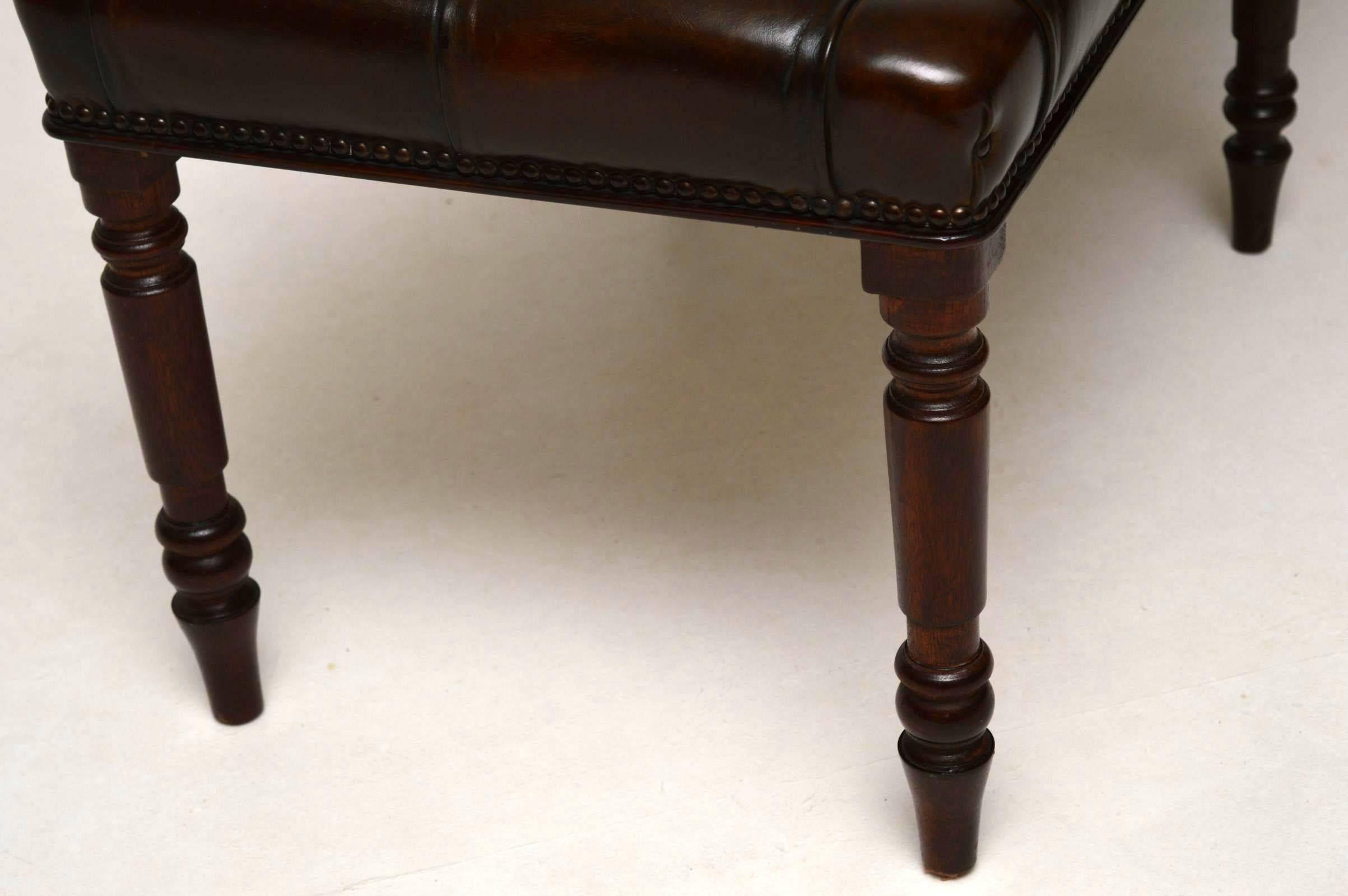Adapted antique deep buttoned leather upholstered stool on a mahogany frame with six turned mahogany legs. This stool has been completely hand made in four stages. The frame and legs were built by my cabinet maker, then it was hand French polished,