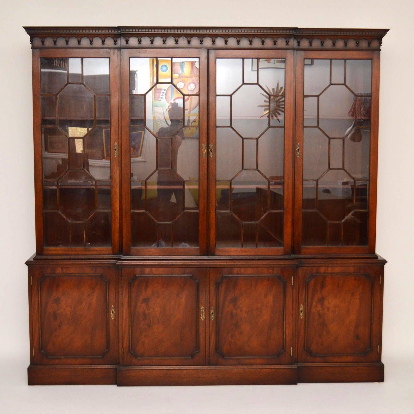 Very impressive, mahogany breakfront bookcase, with four astral glazed doors above and four flame mahogany panelled doors below. The top of this bookcase has a dental cornice, with tear drop mouldings. Inside the top cupboards are fully adjustable