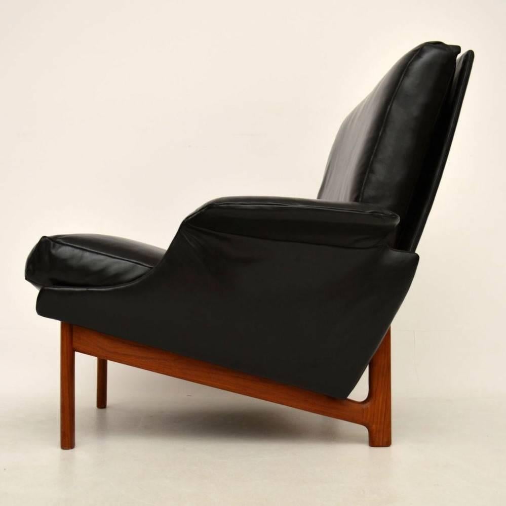 An extraordinary Danish armchair, this was designed by IB Kofod Larsen and was made by Mogens Kold. This is called the Eve chair, there was also a high back version called the Adam chair. These were originally commissioned in 1958 for the opening of