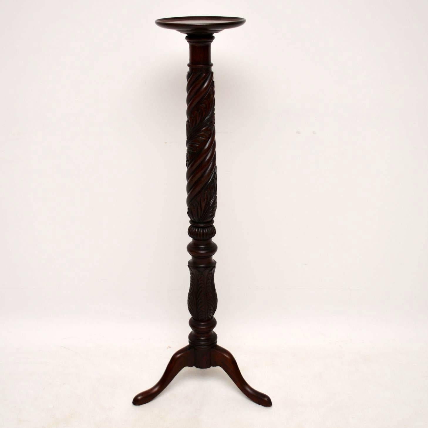 Antique solid mahogany torchere stand with abundant carvings, turnings and designs all down the stem, sitting on tripod legs. It's in excellent original condition and I would date it to around the 1840 period.

Measures: Width 18", 46