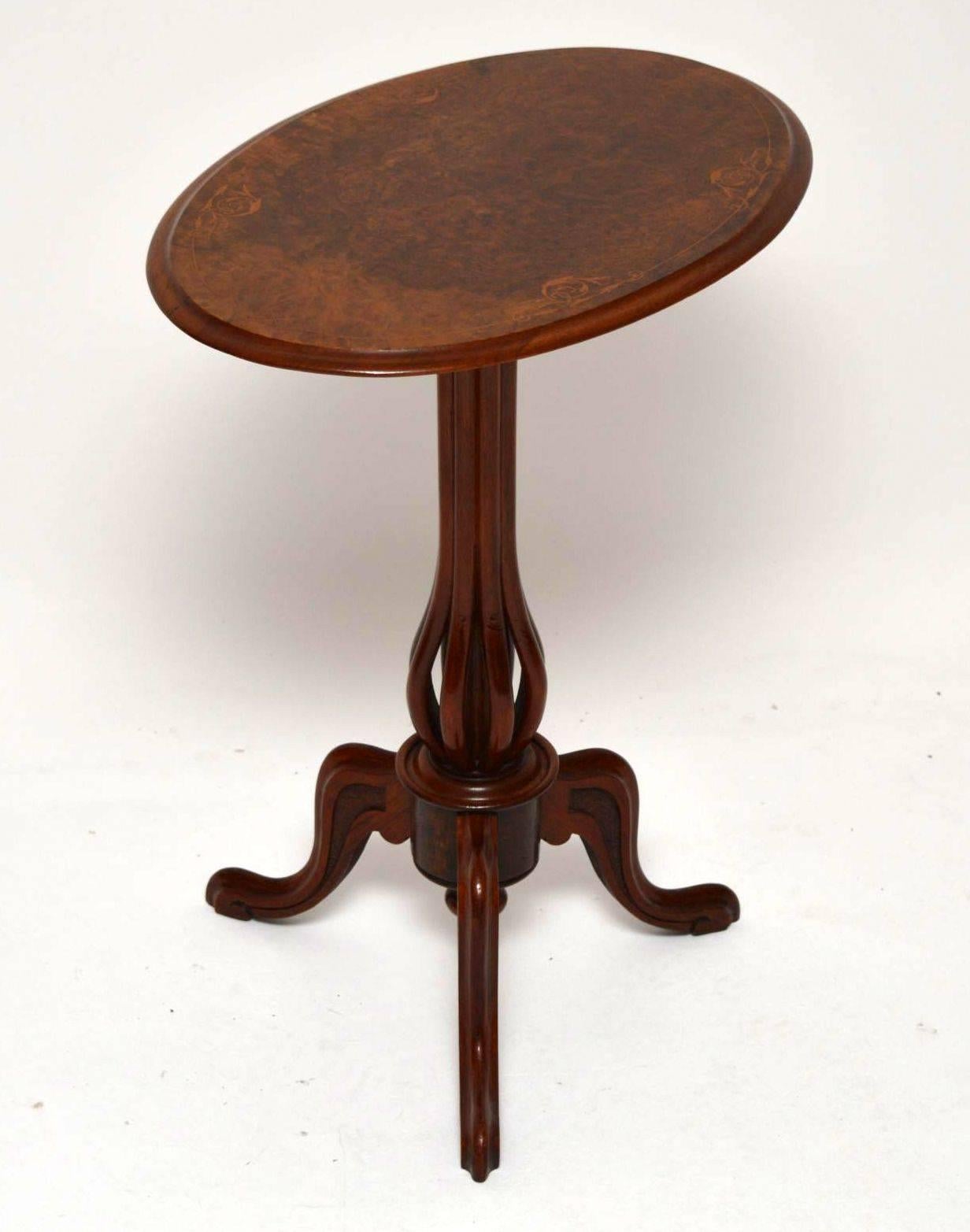 Small antique Victorian oval tilt-top table with a finely inlaid burr walnut top which can be flipped up. This sits on a very unusual column made up of eight walnut sections, that in turn sit on a tripod base. This table is wonderful quality and has