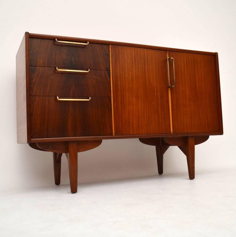 A very stylish and compact sideboard, this dates from the 1950s and is made from a combination of rosewood and tola wood. We have had this stripped and re-polished to a very high standard, the condition is superb throughout.

Measures: Depth: 46