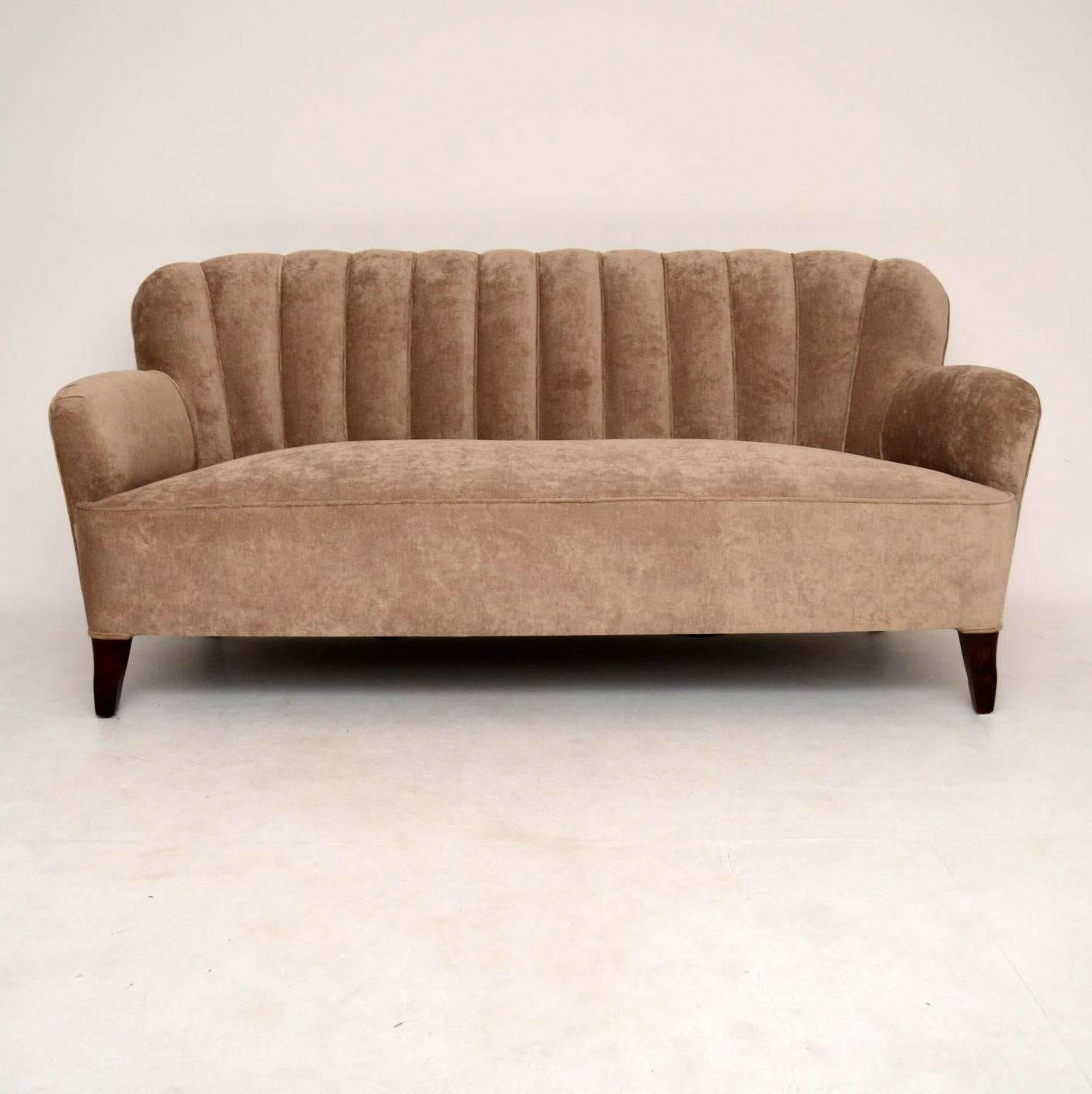 This three-seat fully upholstered 1930s Swedish sofa is very stylish and very comfortable. It comes with a matching pair of armchairs that are also showing in this listing and separately on the web site. Right now I'm selling the suite all together