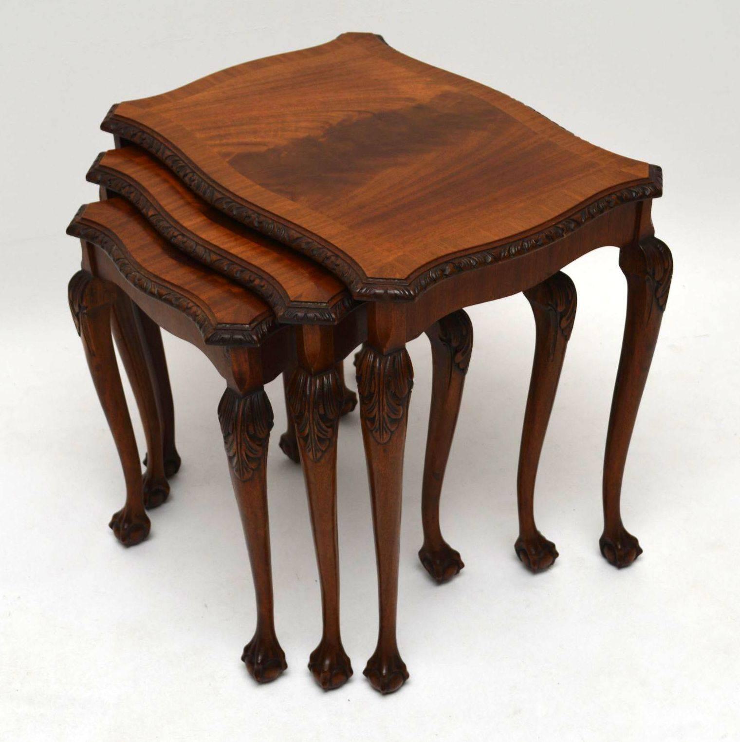Antique nest of tables in mahogany dating from around the 1920s period and in excellent condition. All the table tops are flame mahogany, with crossbanding and carved edges. There is Fine carving on the legs too which also have detailed ball and