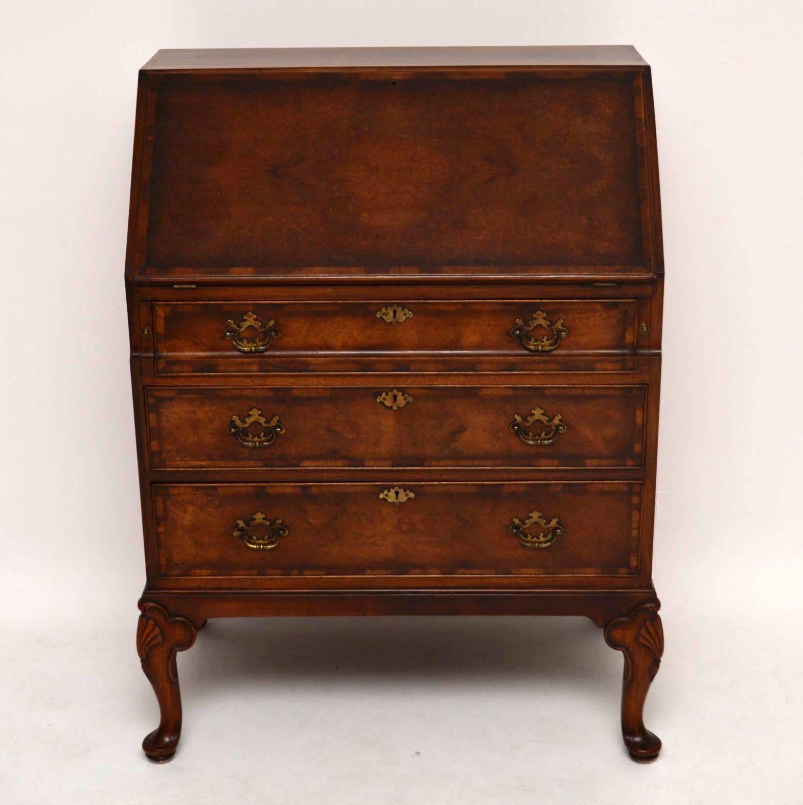 This antique burr walnut bureau is very high quality, so not surprisingly it was made by 'Waring & Gillows' and still bears the metal label. The burr walnut veneers are stunning & give off wonderful patterns, plus rich colours. The pull down slope