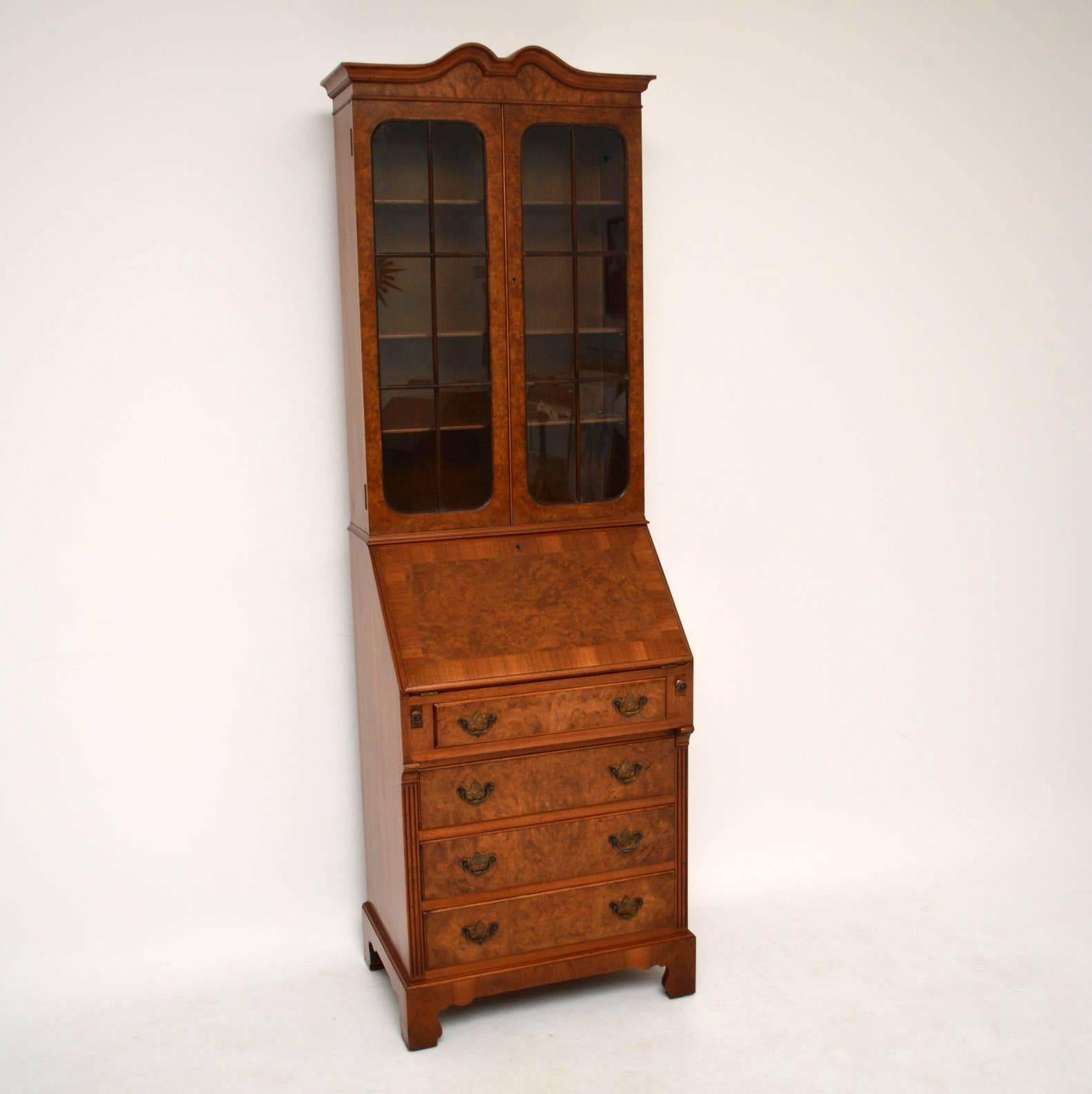 Antique walnut bureau bookcase of slim proportions, in good original condition and dating from around the 1920s period. The frontage is mainly burr walnut & the sides are figured walnut. The top section has a double arched cornice, with two astral