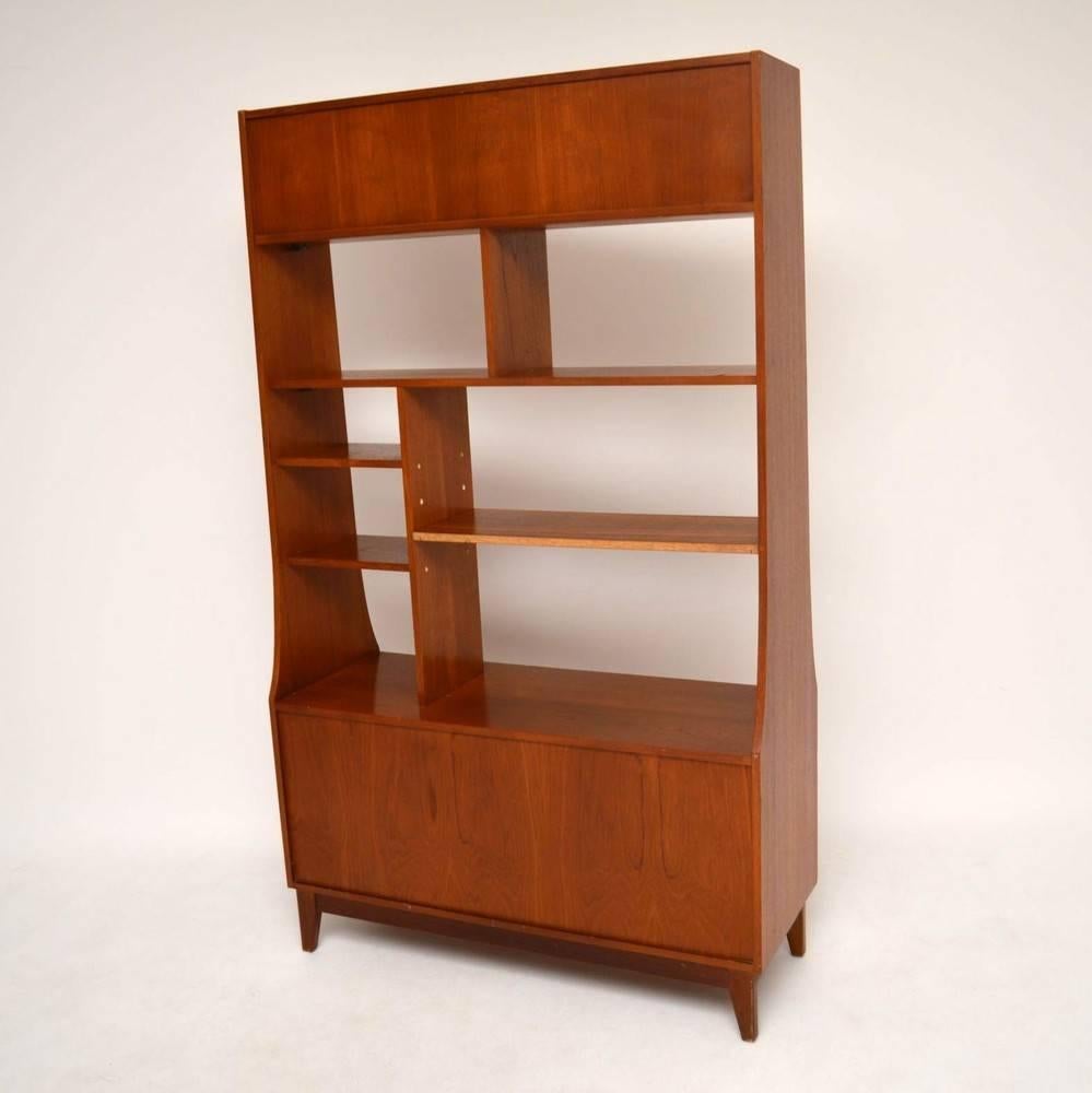 A stylish, extremely well made and practical cabinet in teak, this dates from the 1960s. The quality is excellent and the condition is great for its age, with only some extremely minor wear here and there. The middle shelf is adjustable, we actually