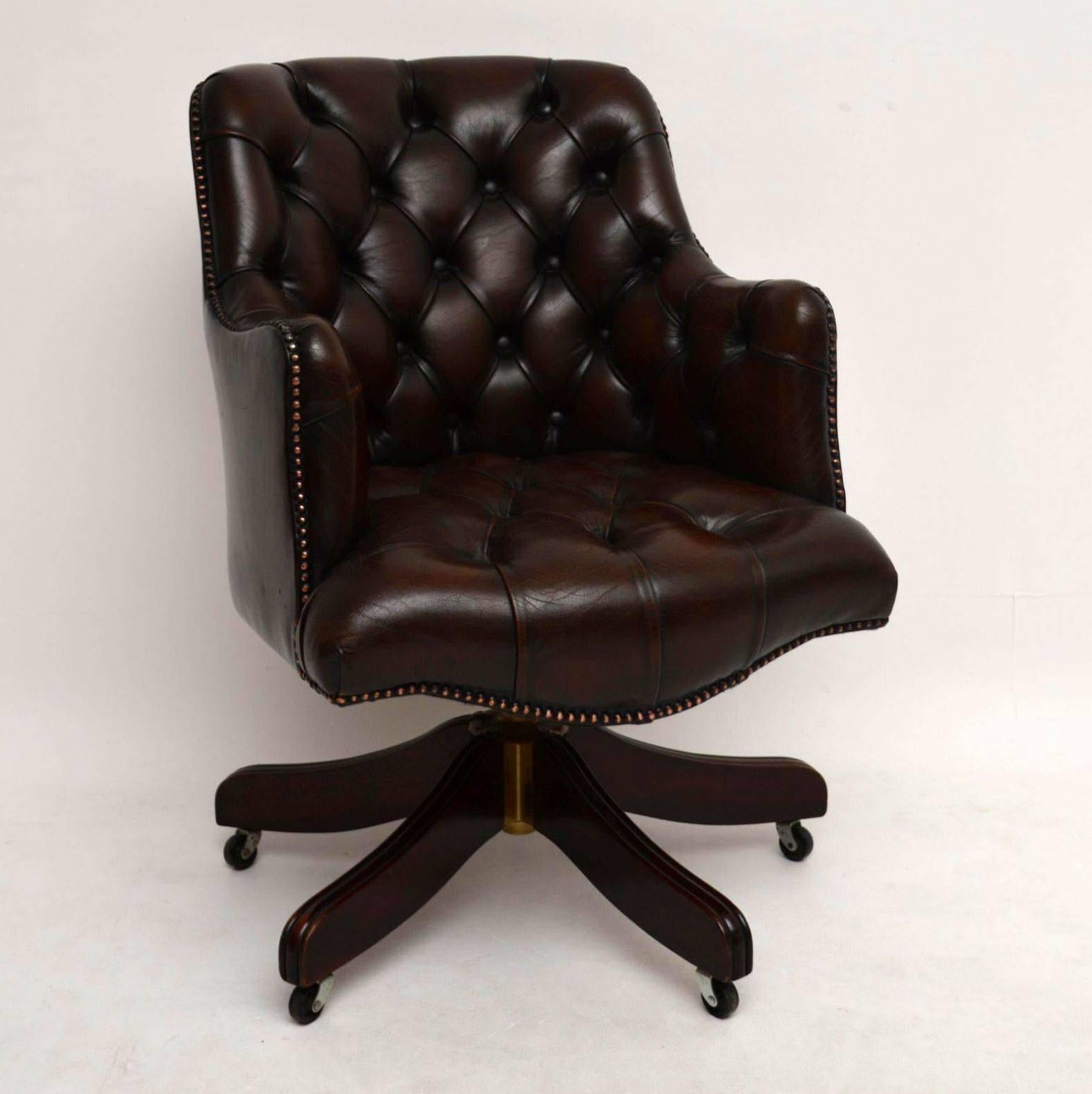 This antique deep buttoned leather swivel desk chair is very comfortable and in good original condition. The leather is all good with no rips or holes and the surface has loads of character. It sits on a mahogany base with wheels underneath. I would