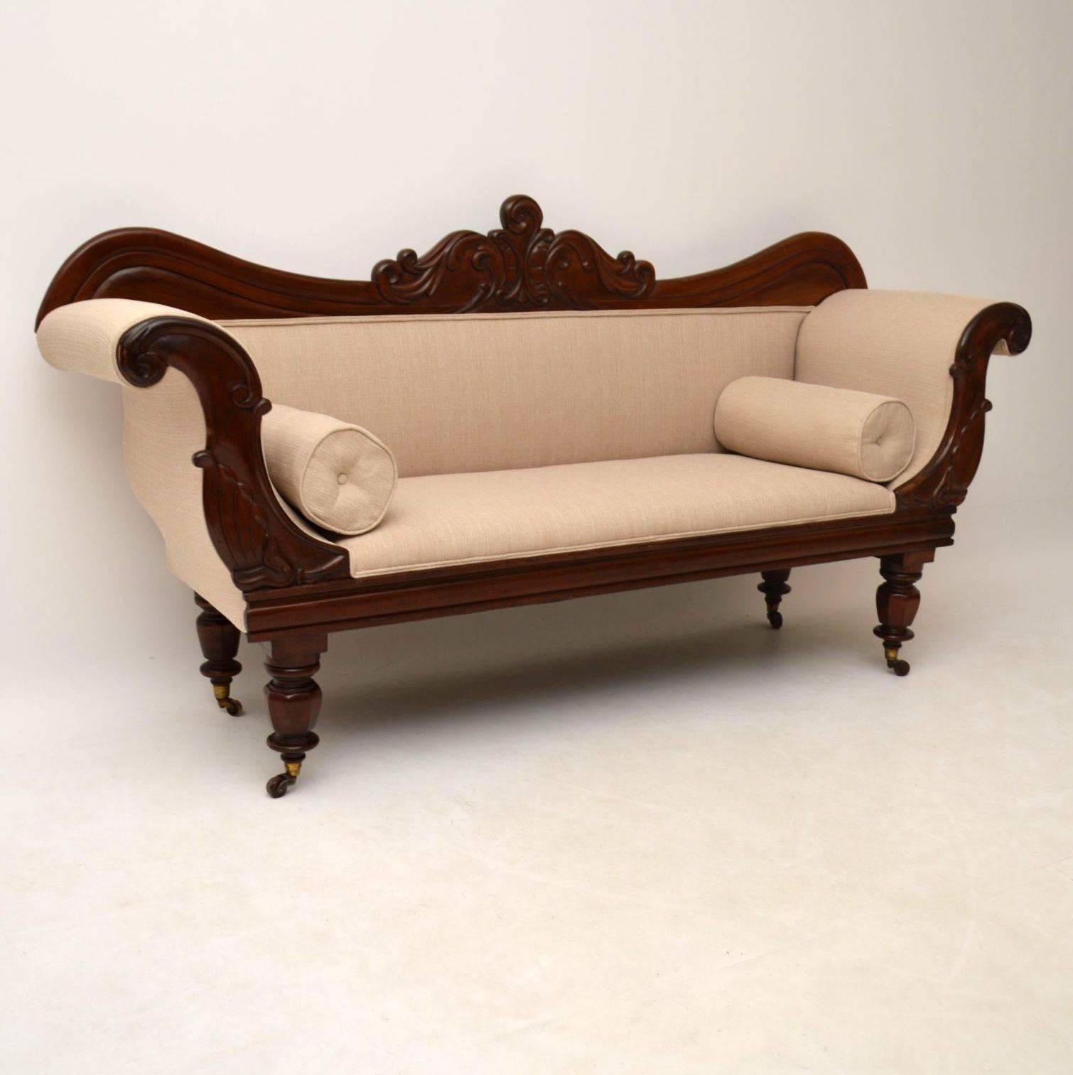 Very impressive antique carved mahogany upholstered sofa, dating from the William IV (1830-1840) period. It's in fabulous original condition, with all the carvings intact and even still has the original brass cupped porcelain casters. The frame is