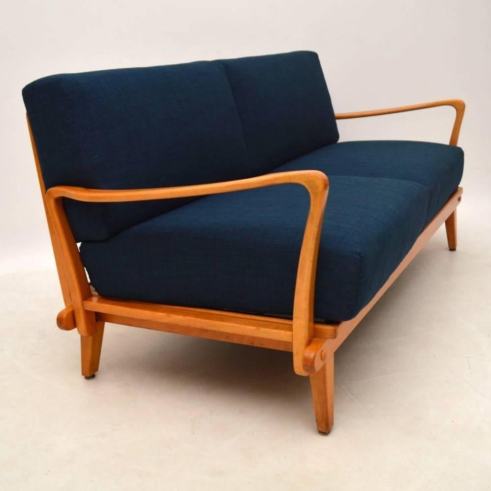 A beautifully styled, comfortable and top quality sofa bed, this was made by Wilhelm Knoll, it dates from the 1950s-1960s. The condition is excellent for its age; the cherry wood frame is clean and sturdy, with only some minor wear here and there.