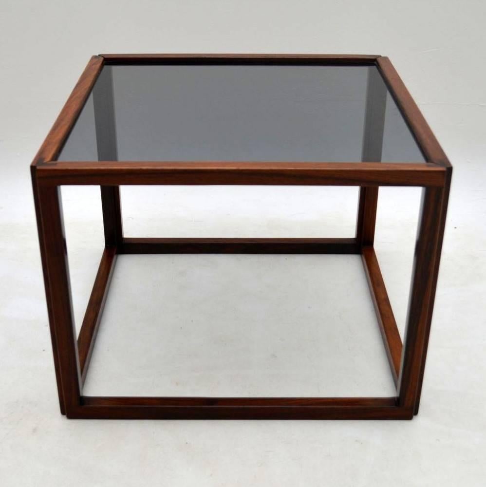 A top quality solid rosewood coffee table, this was designed by Kai Kristiansen, it dates from the 1960s. It's in excellent condition for its age, with only some extremely minor wear here and there, and one or two small marks on the glass
