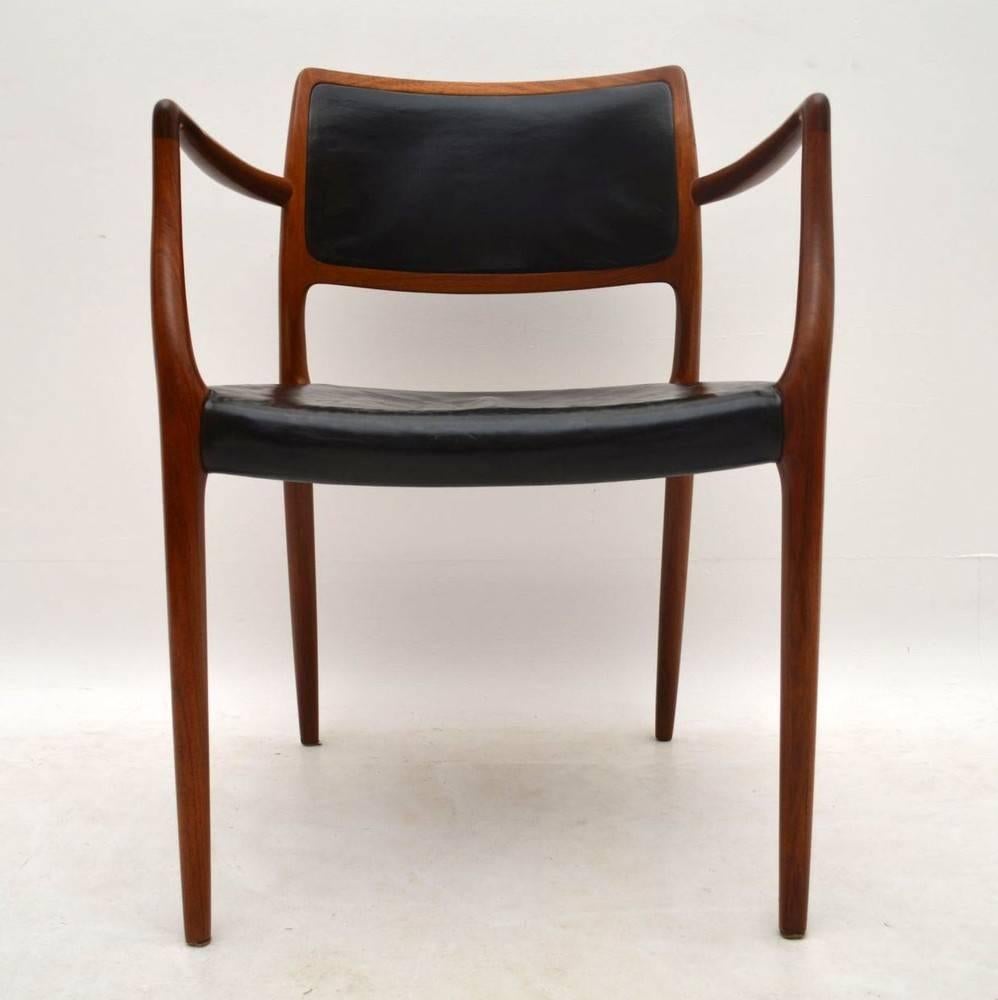 A stunning and top quality Danish armchair in solid Rosewood and original black leather. This was designed by Niels Møller, it dates from the 1960s. We have had the frame stripped and re-polished to a very high standard, the color and grain patterns