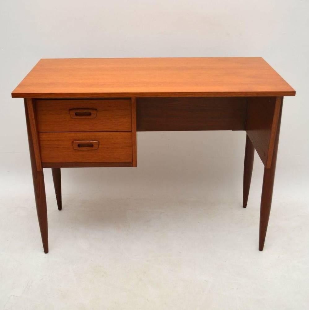 A stylish and very practical desk in Teak, this was made in Denmark, it dates from the 1960s. It has a beautiful tapered shape and is nicely finished on the back, so can be used as a freestanding piece. We have had this stripped and re-polished to a