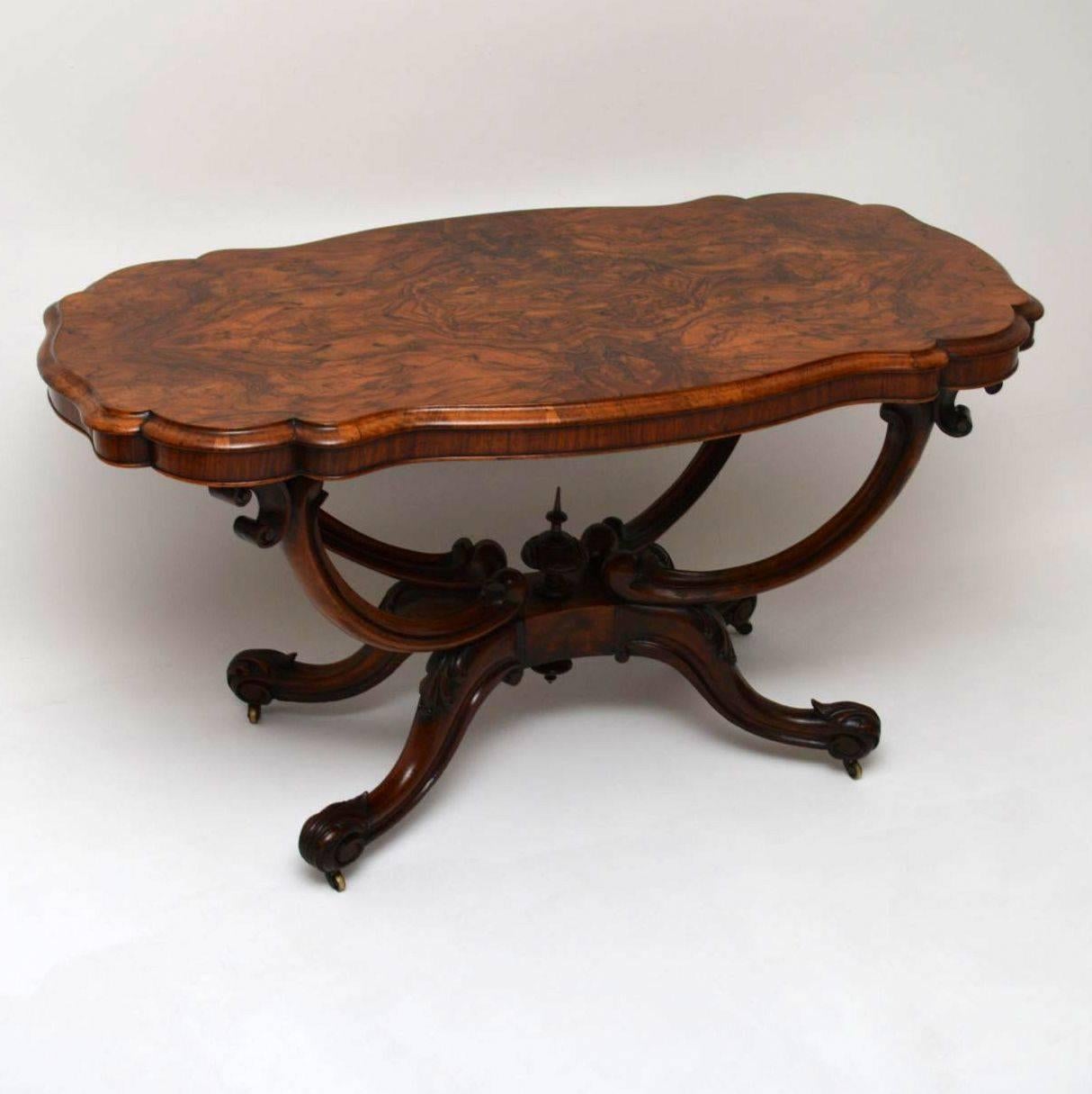 This antique Victorian centre table is a stunning piece of furniture and is 100% original. It has a shaped scalloped burr walnut top with amazing patterns within the veneers, which sits on top of a solid walnut basket shaped base. This table has a