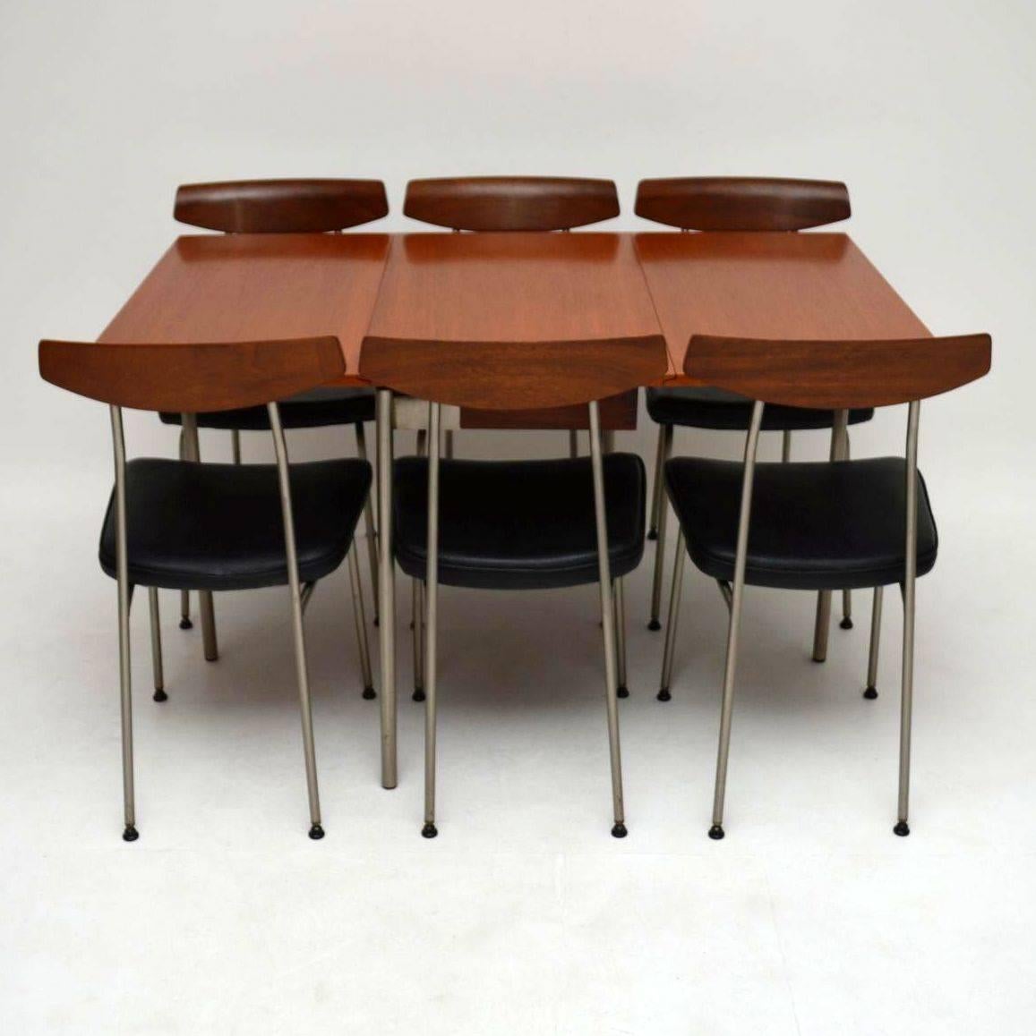 A stunning and rare vintage dining table and chairs, these were designed by John and Sylvia Reid for Stag Furniture’s S range, they date from the 1950s-1960s. This consists of a teak drop leaf dining table with steel legs, and six teak back dining