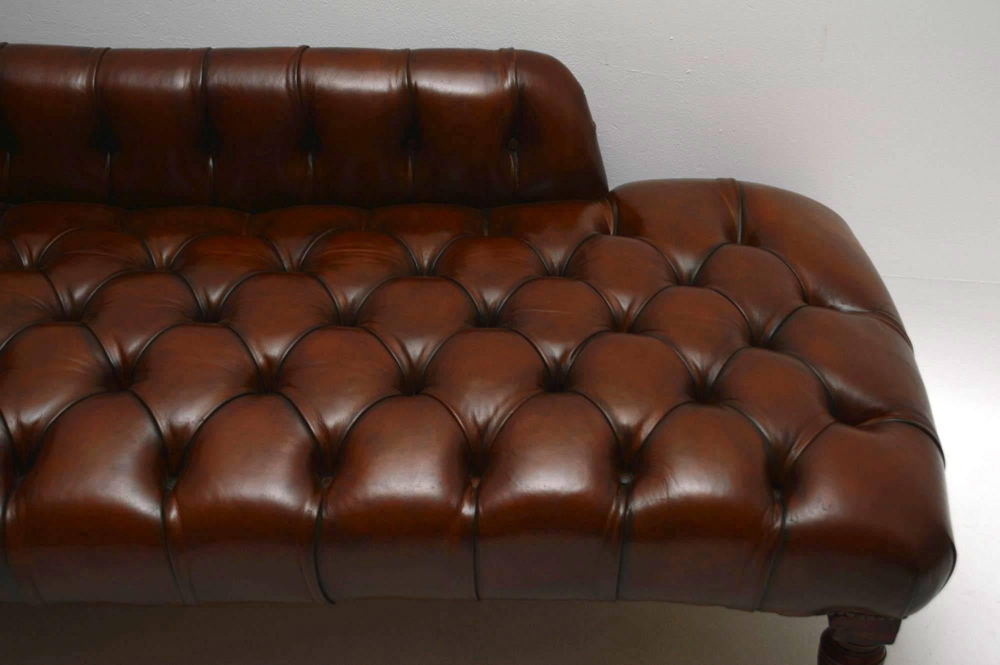 This is an original Victorian chaise lounge that has been completely re-upholstered in deep buttoned leather, then hand colored and antiqued by a leather specialist. The mahogany legs are turned & reeded with original brass casters. This chaise has