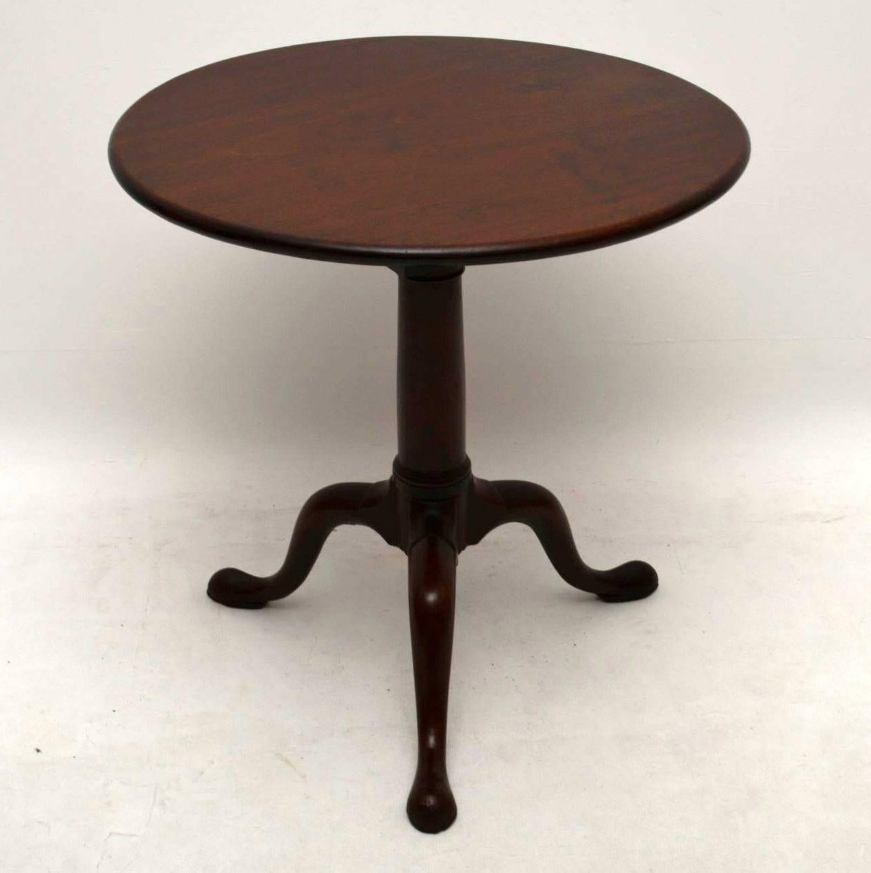 This is an antique period solid mahogany table in good condition, having just been polished and dates to circa 1760-1780 period. It has a round one piece top which tilts and spins around on a birdcage mechanism. During the 18th century the tripod