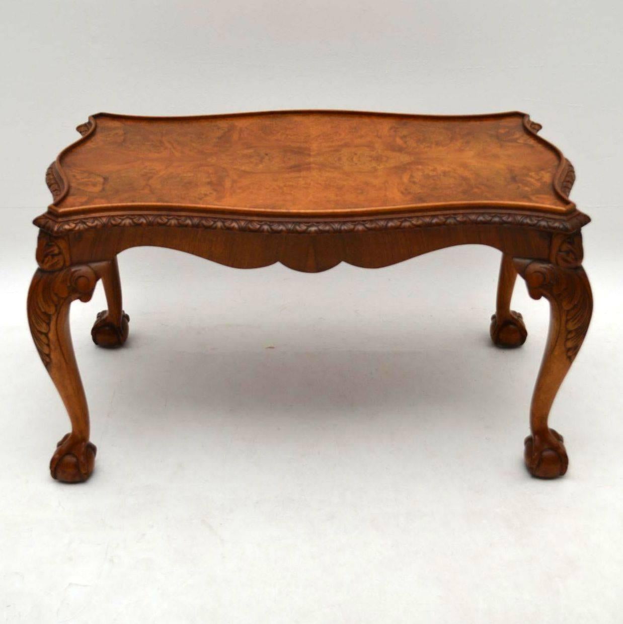 High quality antique walnut coffee table with a great shape and very fine details. It’s beautifully carved all-over right down to the ball and claw feet. The tabletop is burr walnut, the sides figured walnut and the legs are solid walnut. This table