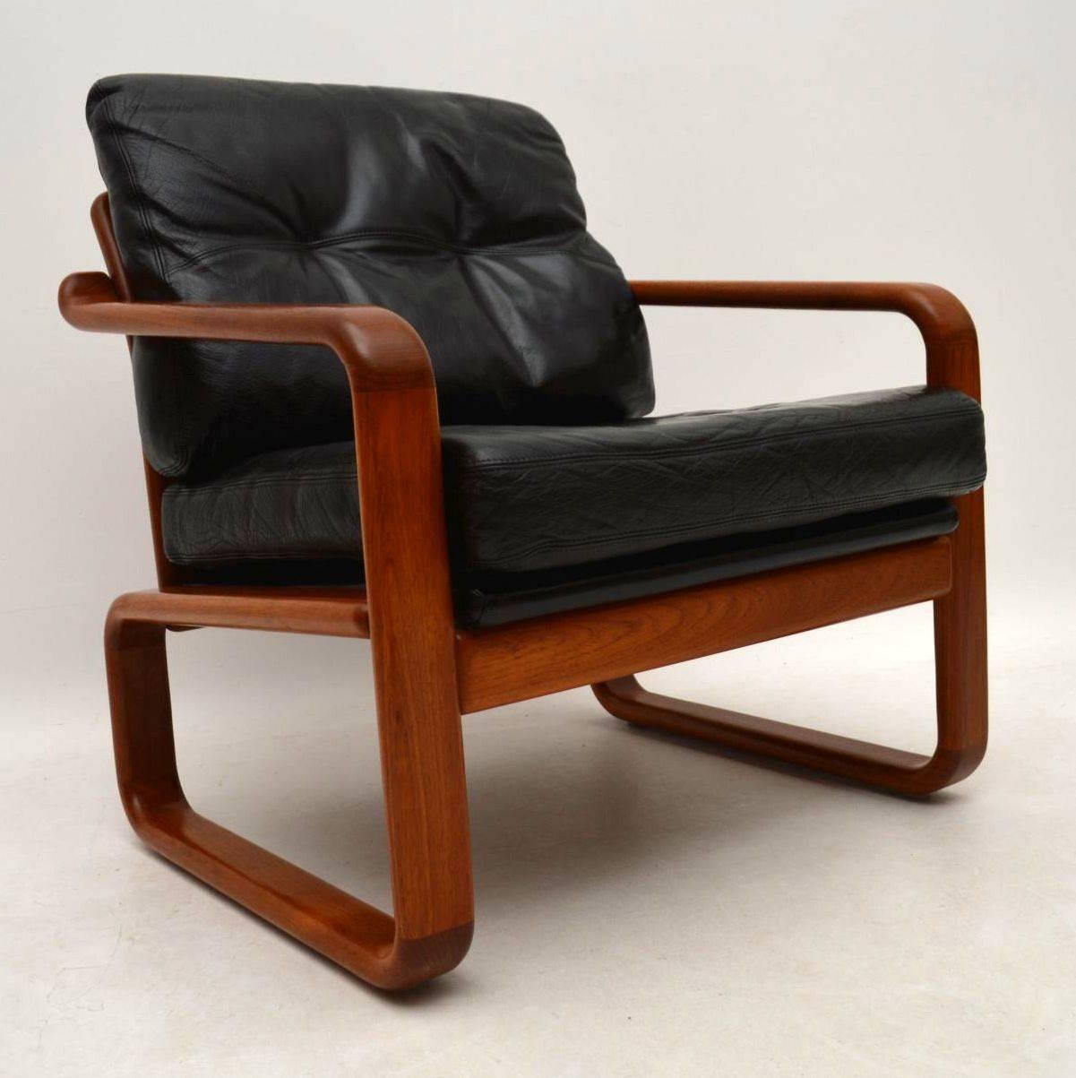 A very stylish and extremely comfortable pair of vintage armchairs, these were made in Denmark and date from around the 1960s-1970s. The quality is amazing, they have a solid teak frames and black leather cushions. The condition is superb for its
