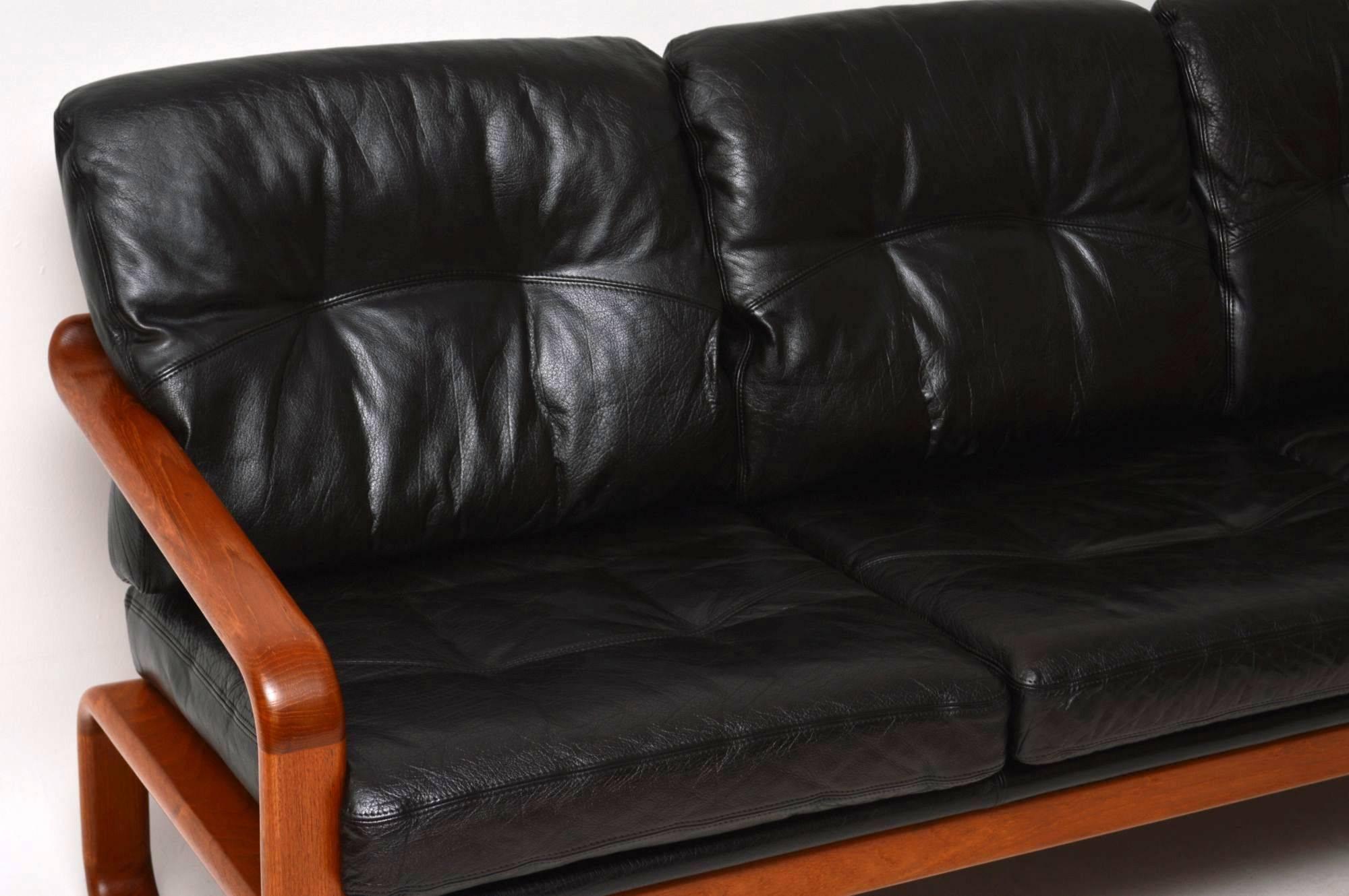 A very stylish and extremely comfortable vintage sofa, this was made in Denmark and dates from circa 1960s-1970s. The quality is amazing, it has a solid teak frame and black leather cushions. The condition is superb for its age, we have had the
