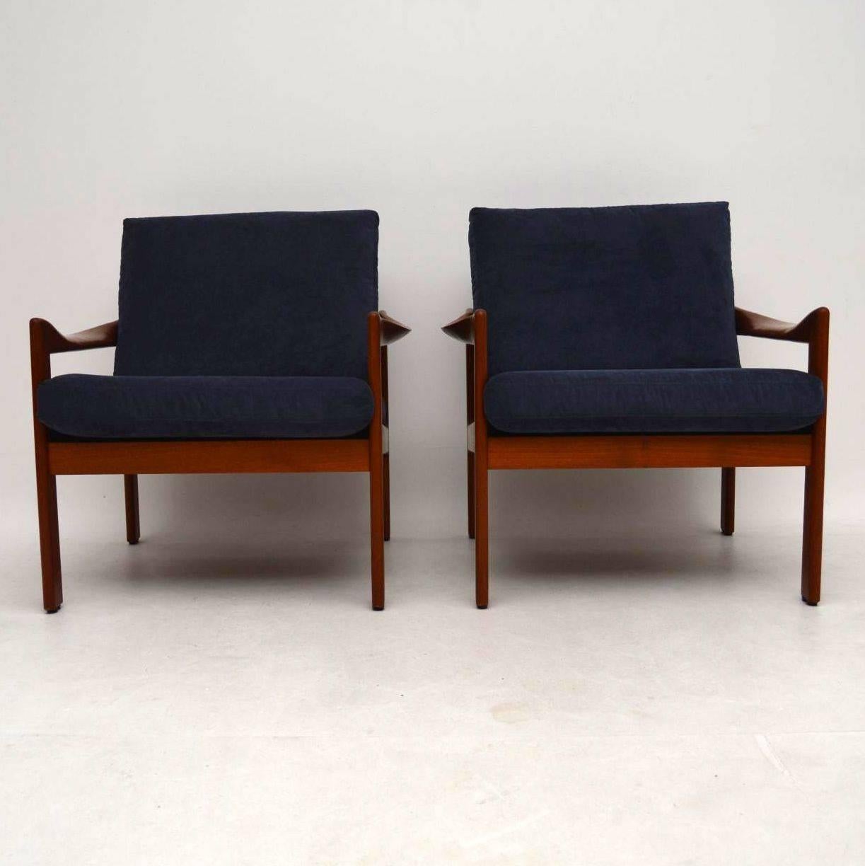 A stunning and rare pair of Danish vintage armchairs in solid teak, these were designed by Illum Wikkelso for Niels Eilersen and they date from the 1960s. The condition is superb for their age, the solid teak frames are clean, sturdy and sound; we
